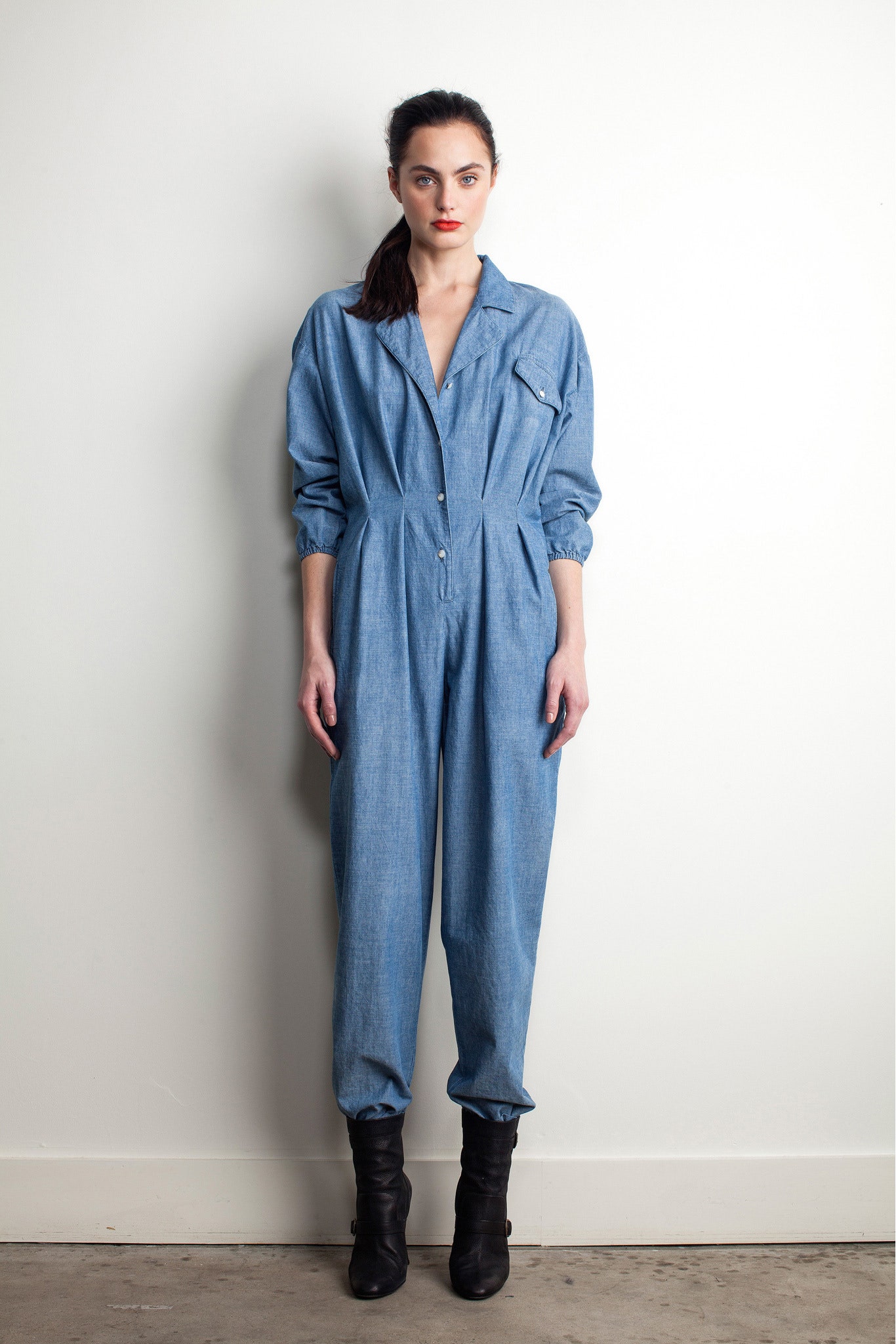 blue denim jumpsuit with black boots