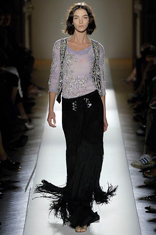 purple embroidered silk top and black fringed skirt