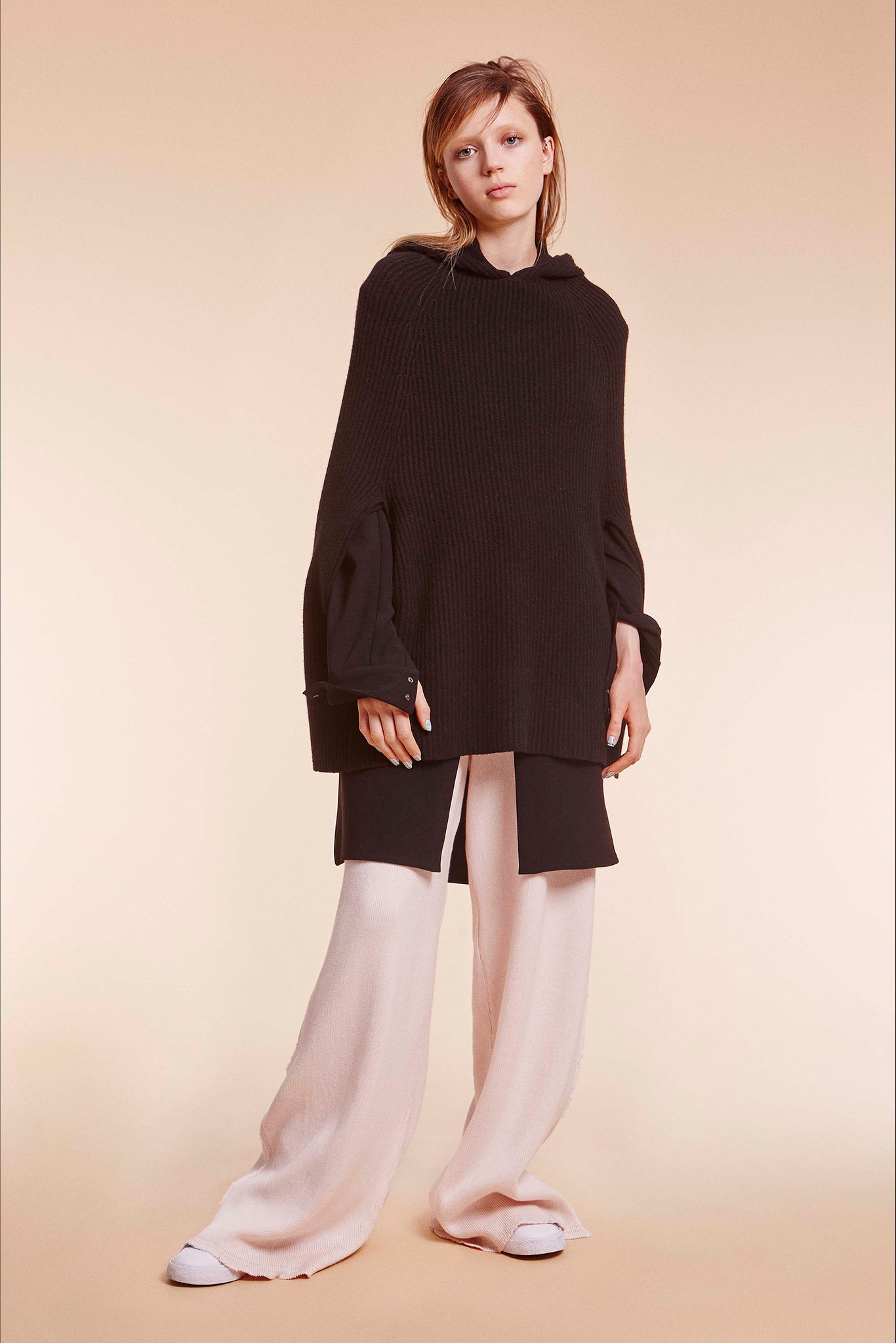 oversized black top with relaxed beige pants