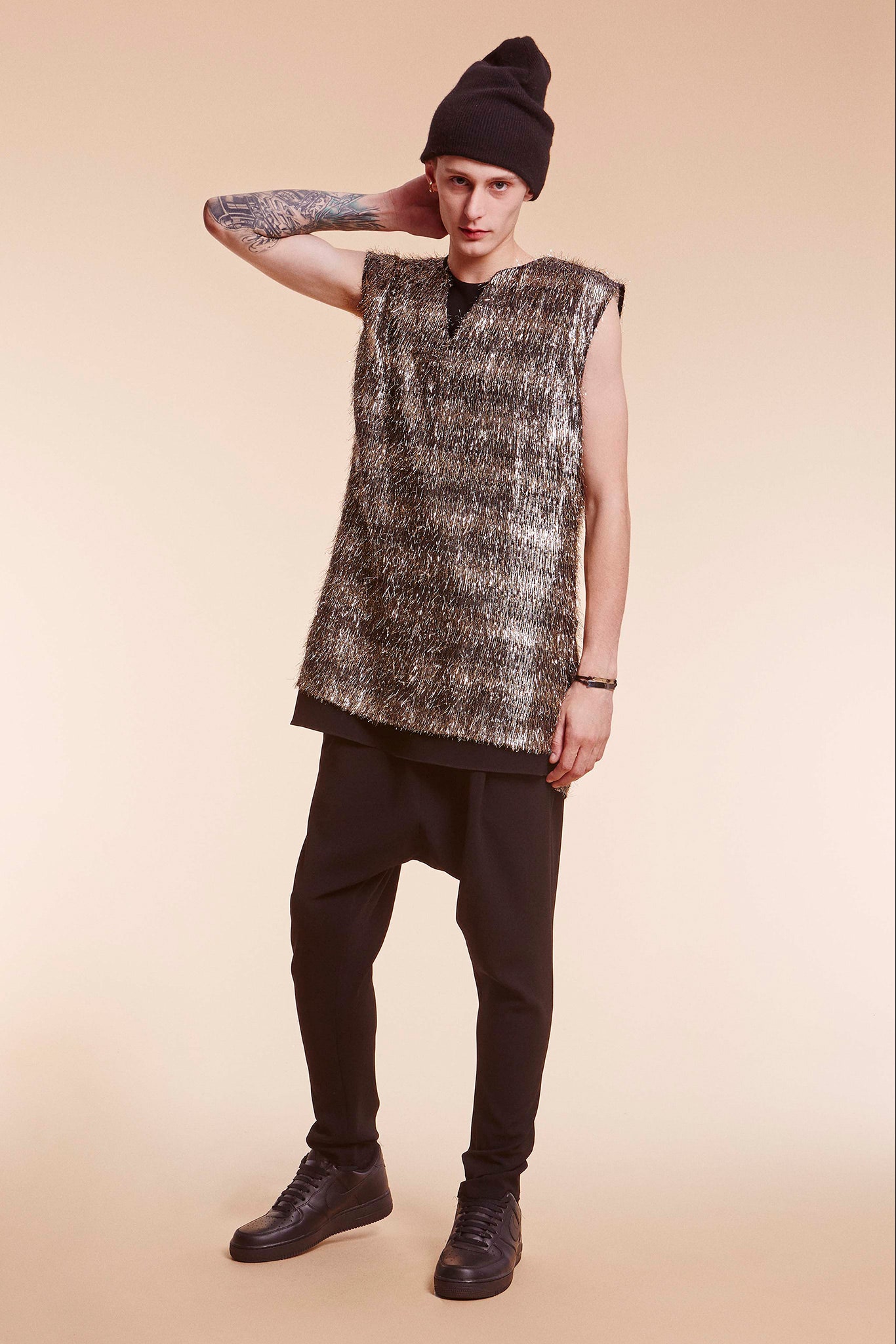 gray wool sleeveless top with black pants