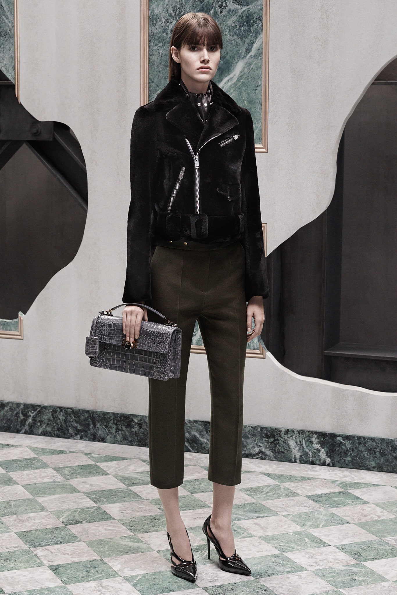 black leather fitted jacket with green tailored pants