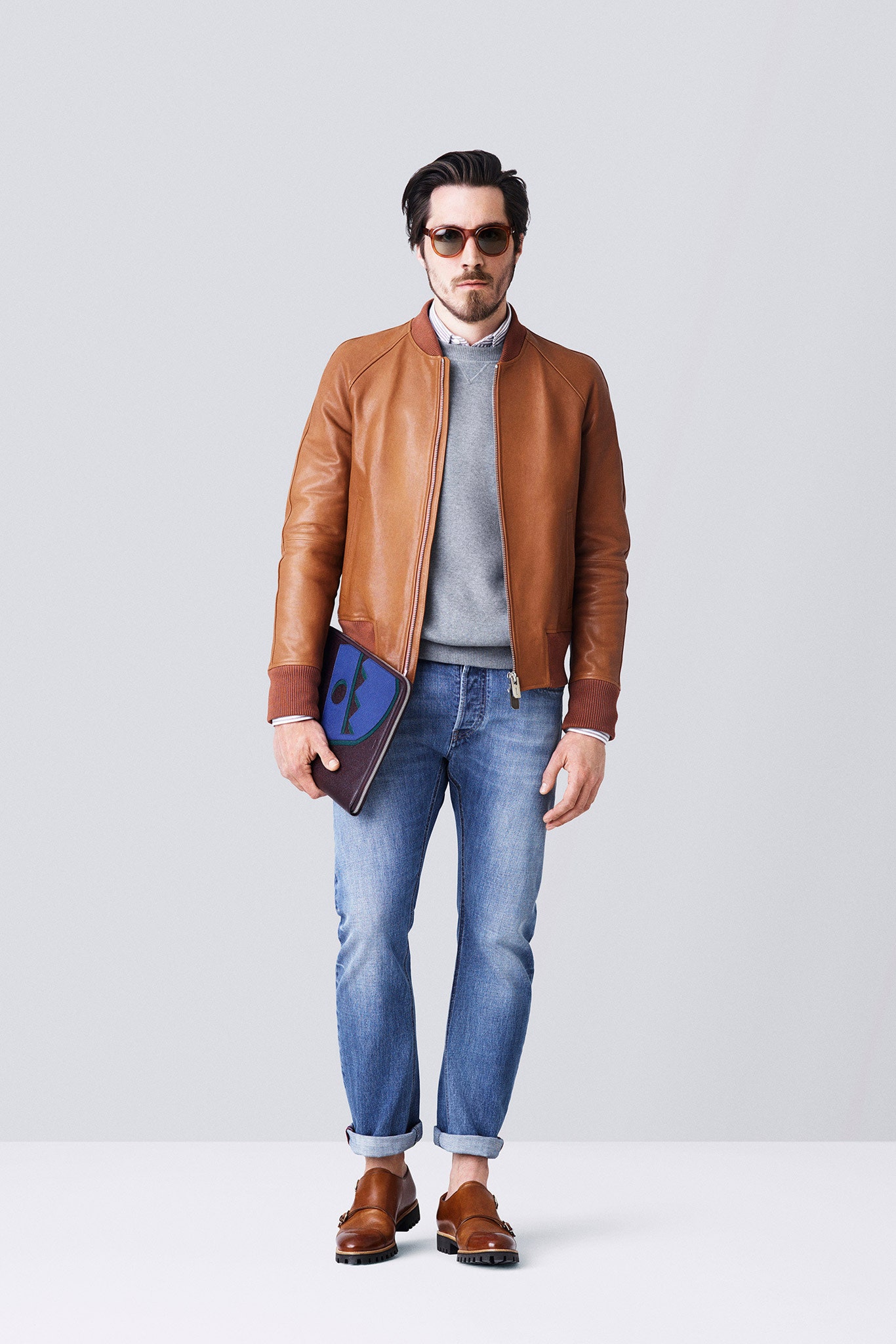 brown leather jacket with gray sweater