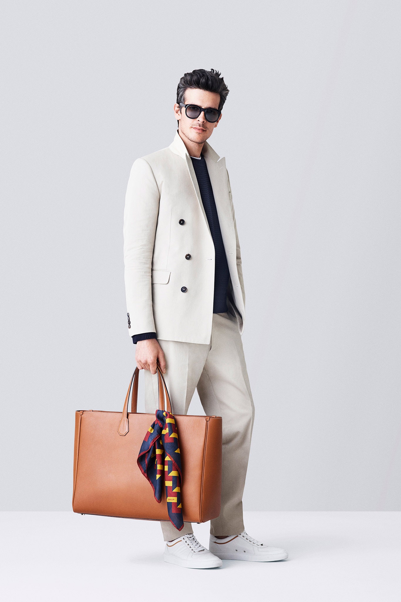 beige tailored suit with navy shirt