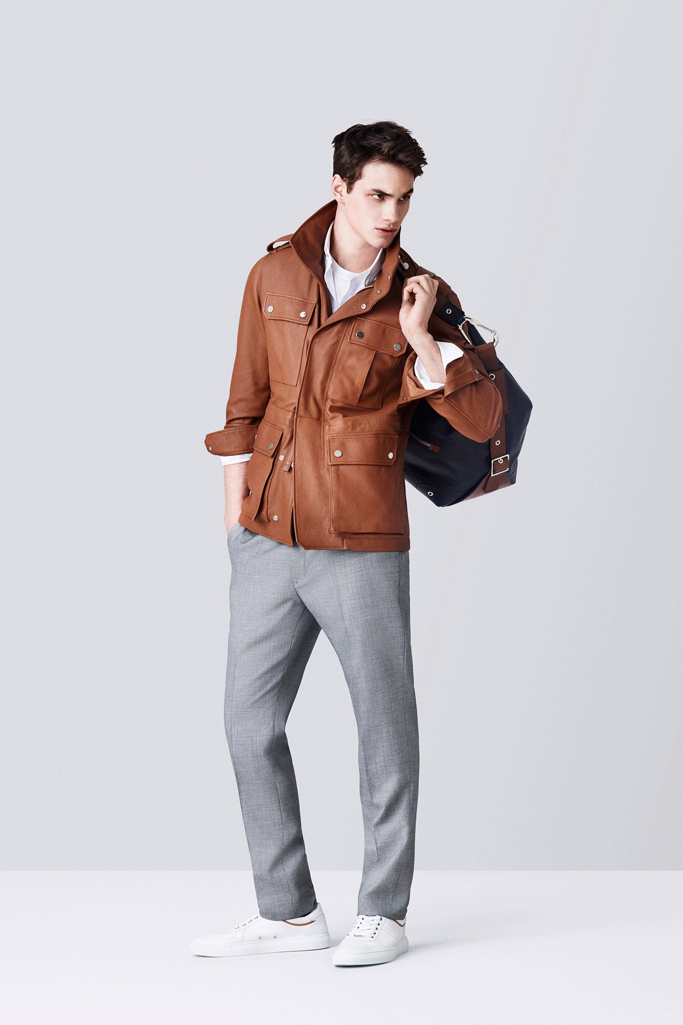 brown leather jacket with gray pants