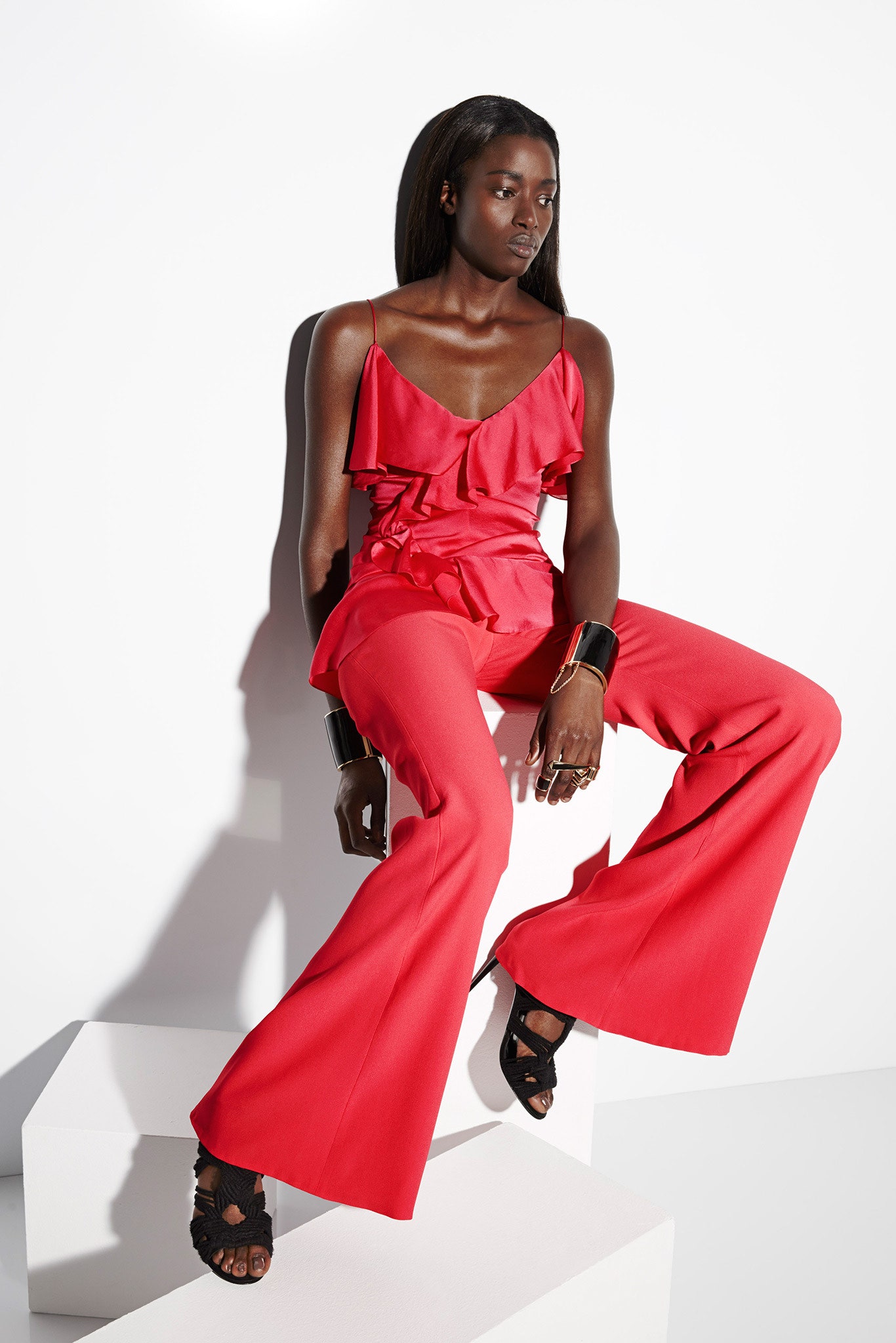 red ruffled top with flared pants