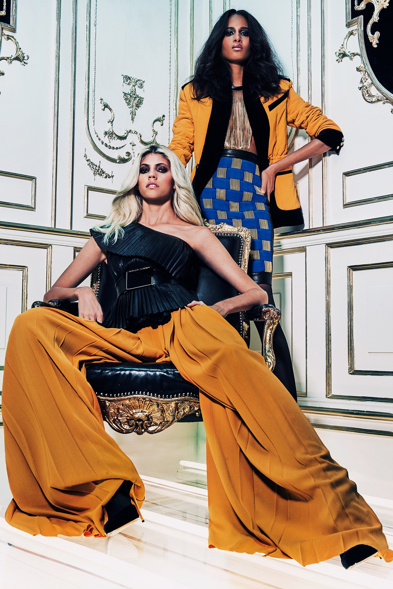 black silk one-shoulder jumpsuit and orange wide-leg pants