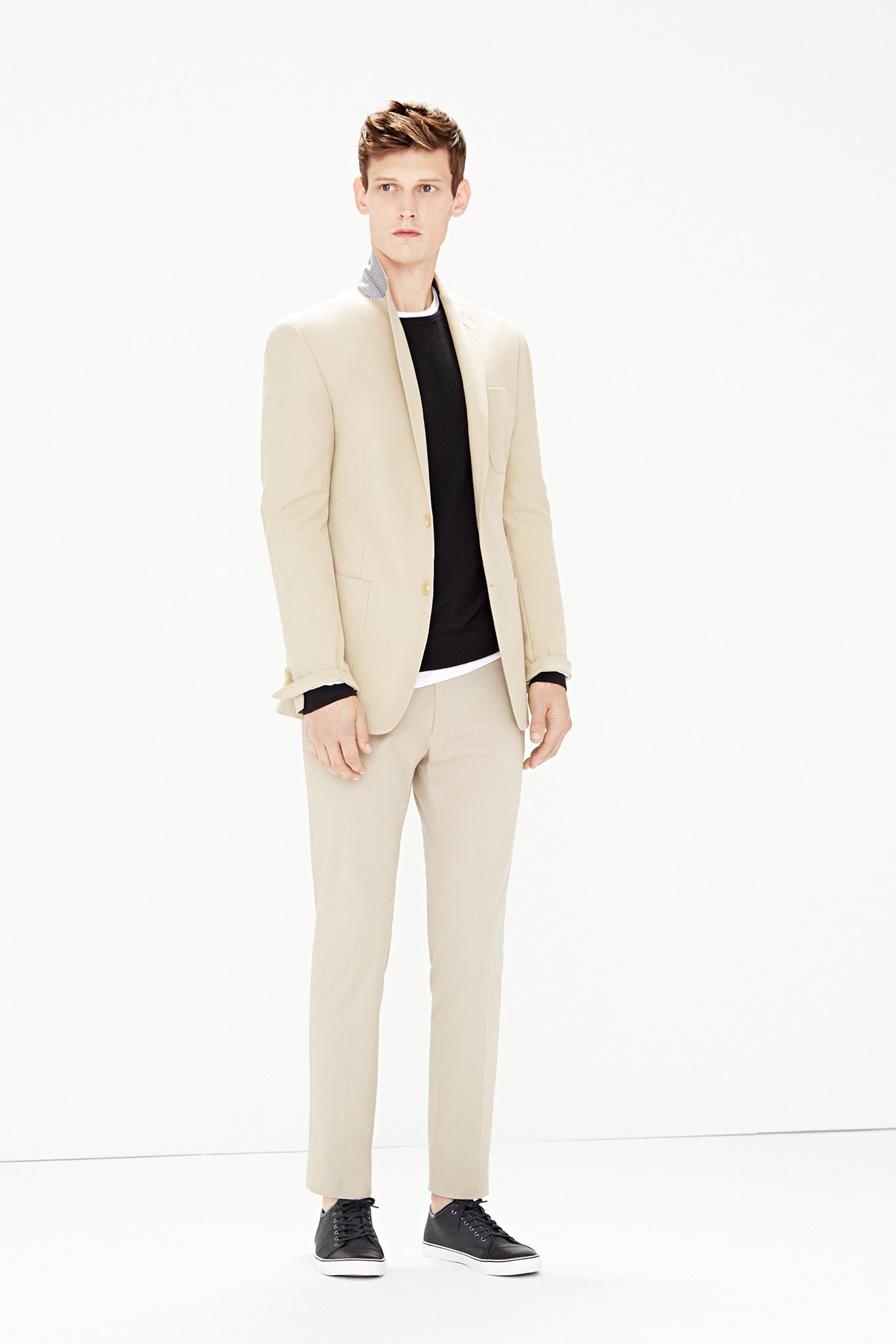 beige tailored suit with black shirt
