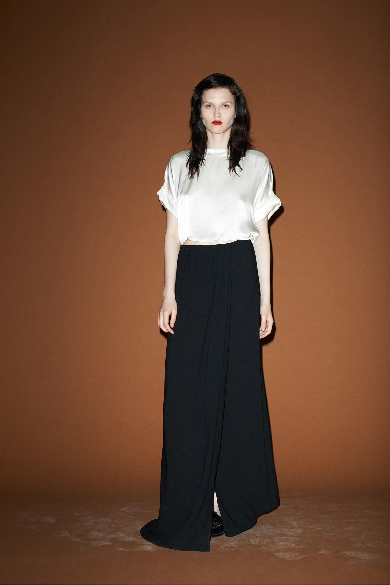 white silk top and black pleated skirt