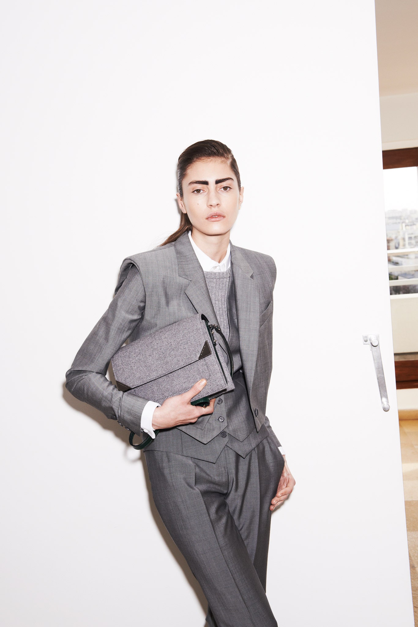 gray tailored suit with bag