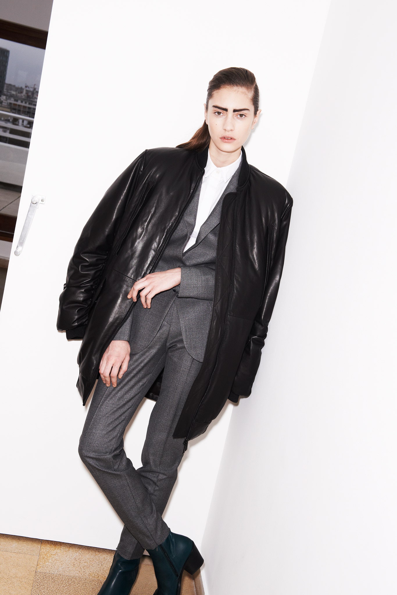 black leather oversized coat with gray suit