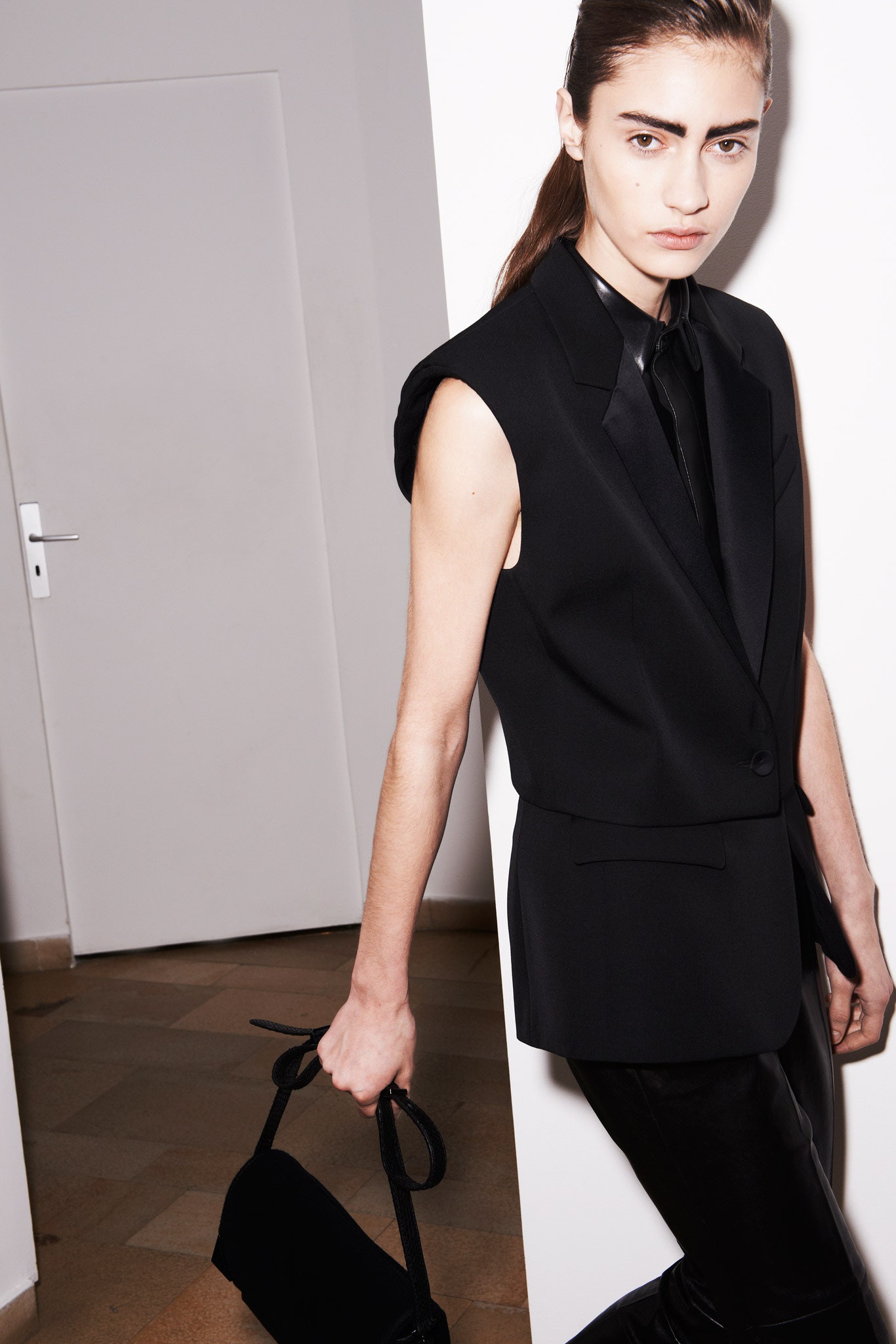 black tailored sleeveless blazer and fitted pants