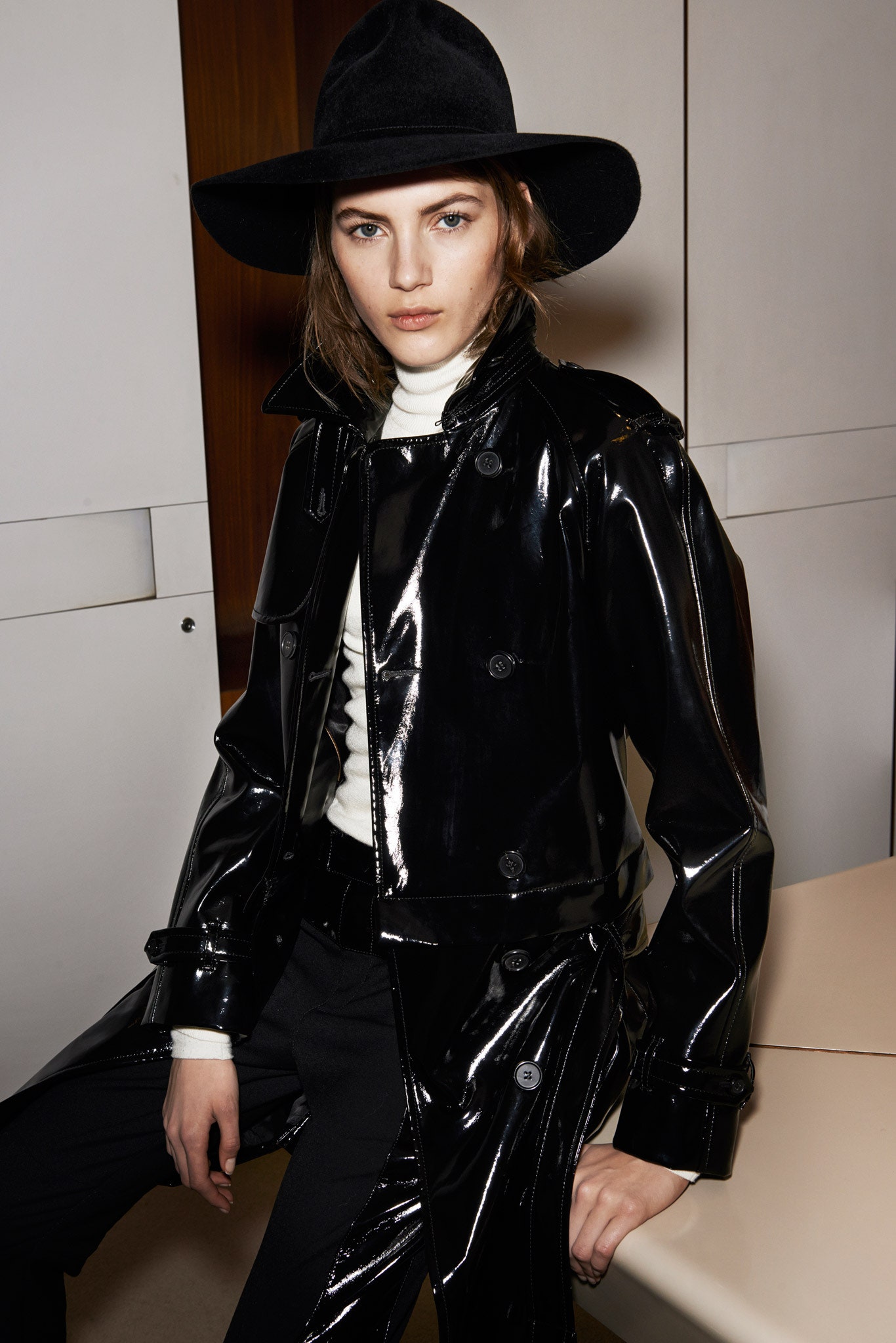 black vinyl long-sleeve collared fitted zippered shiny trench