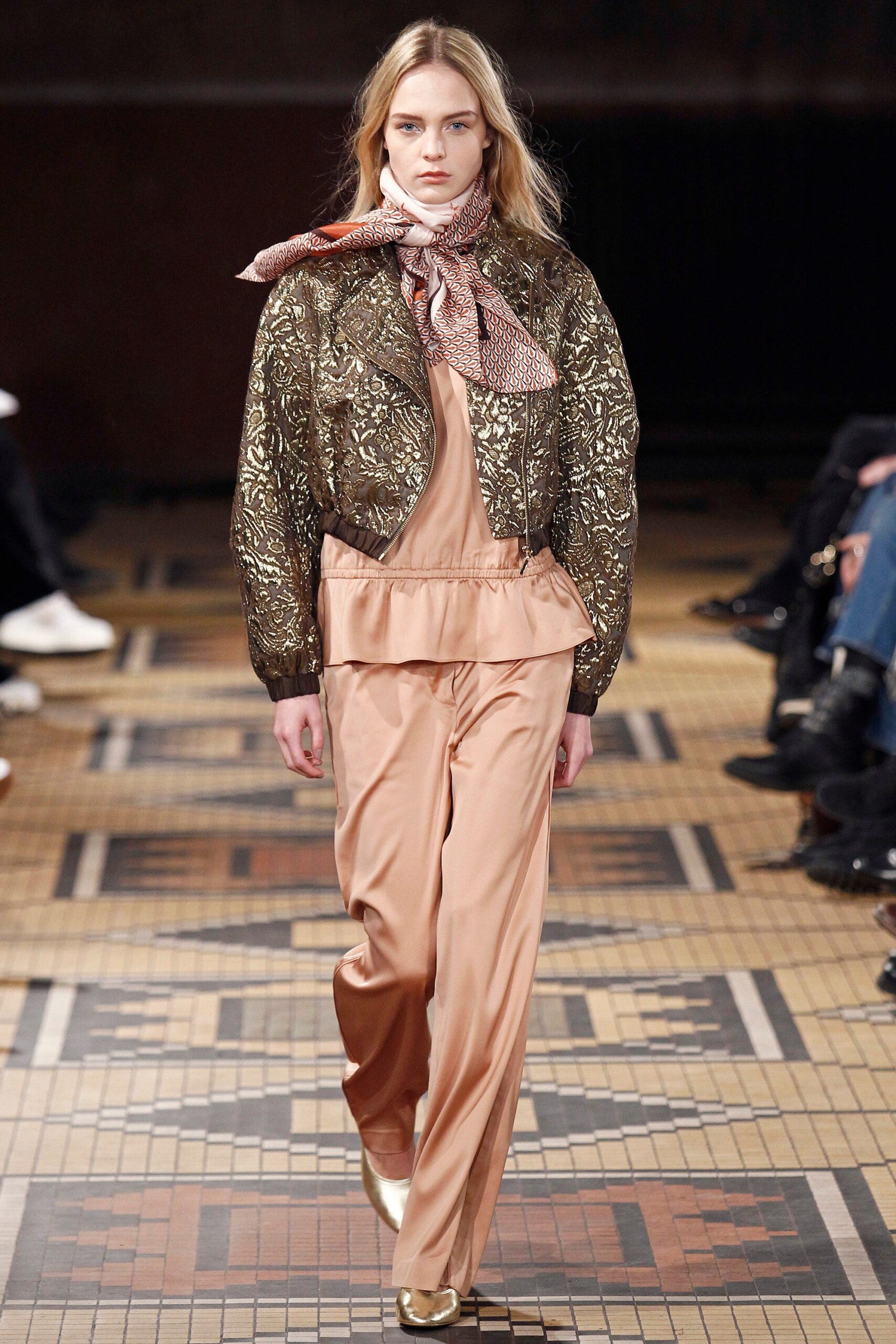 gold embroidered jacket with beige pants