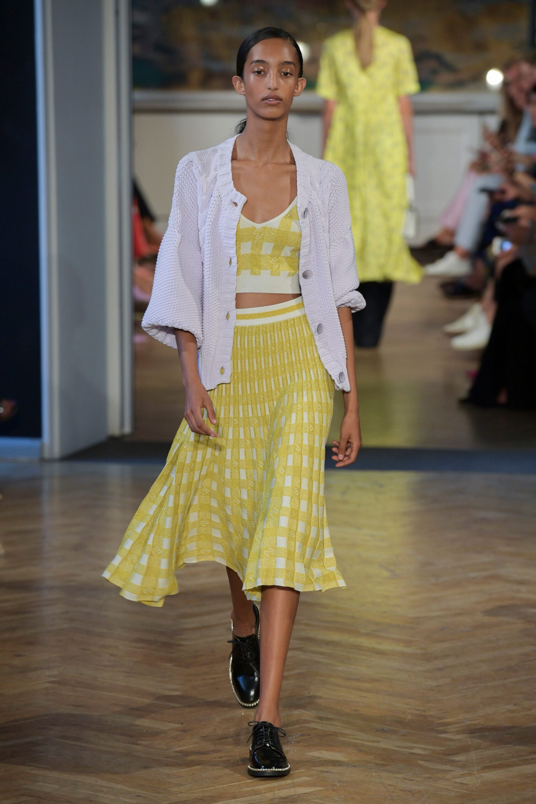 yellow checked top and skirt with white jacket
