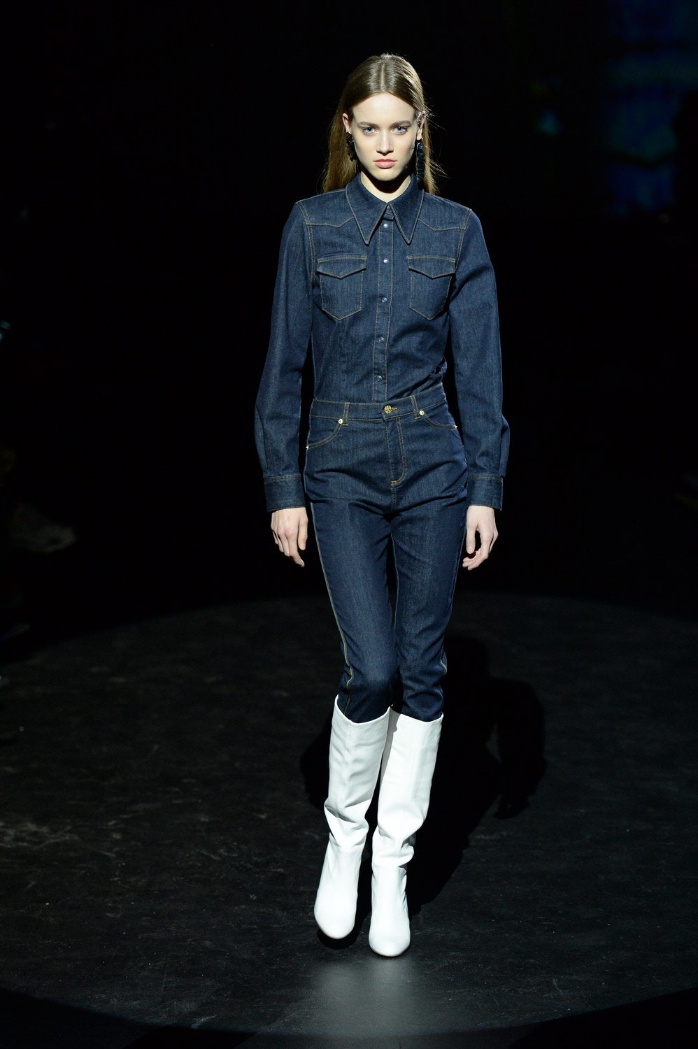 blue denim fitted jumpsuit with white boots