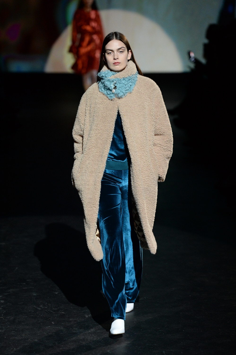 beige faux-fur coat with blue velvet jumpsuit