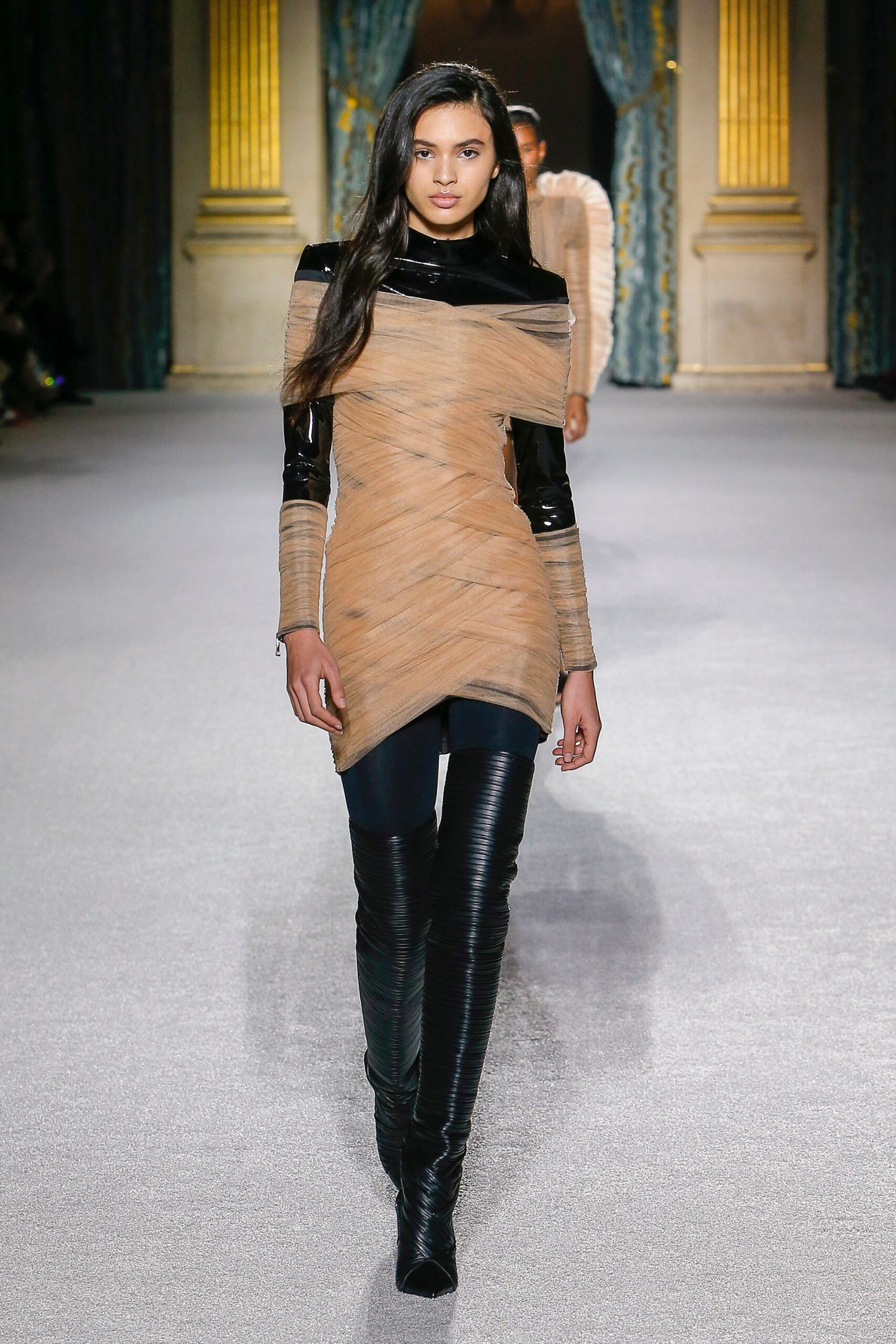 fitted beige and black dress with vinyl pants