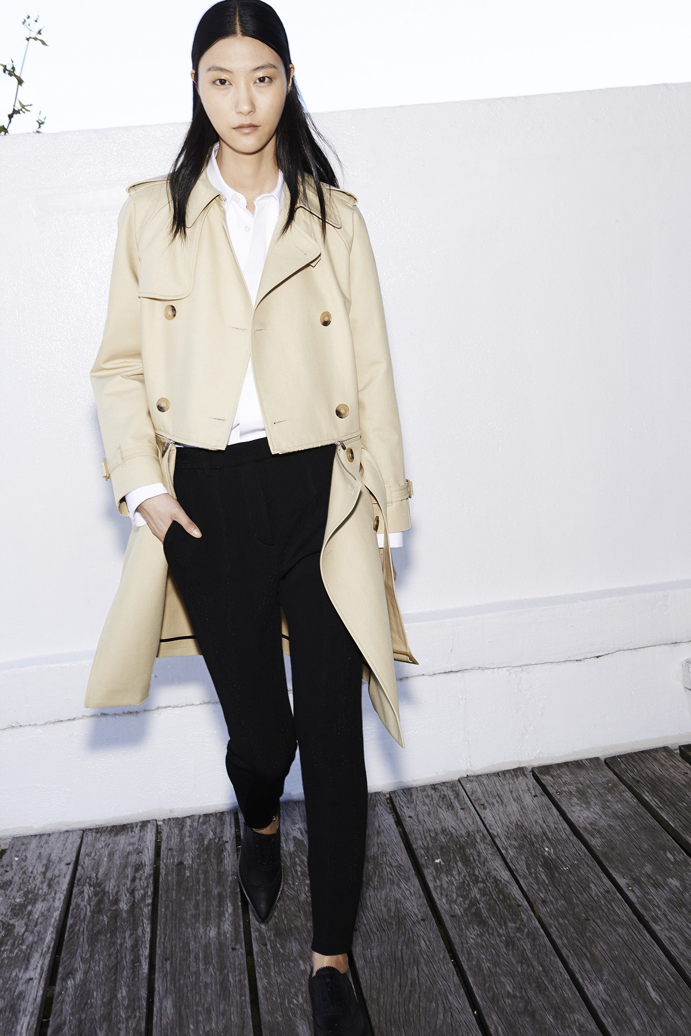 beige trench coat with black pants