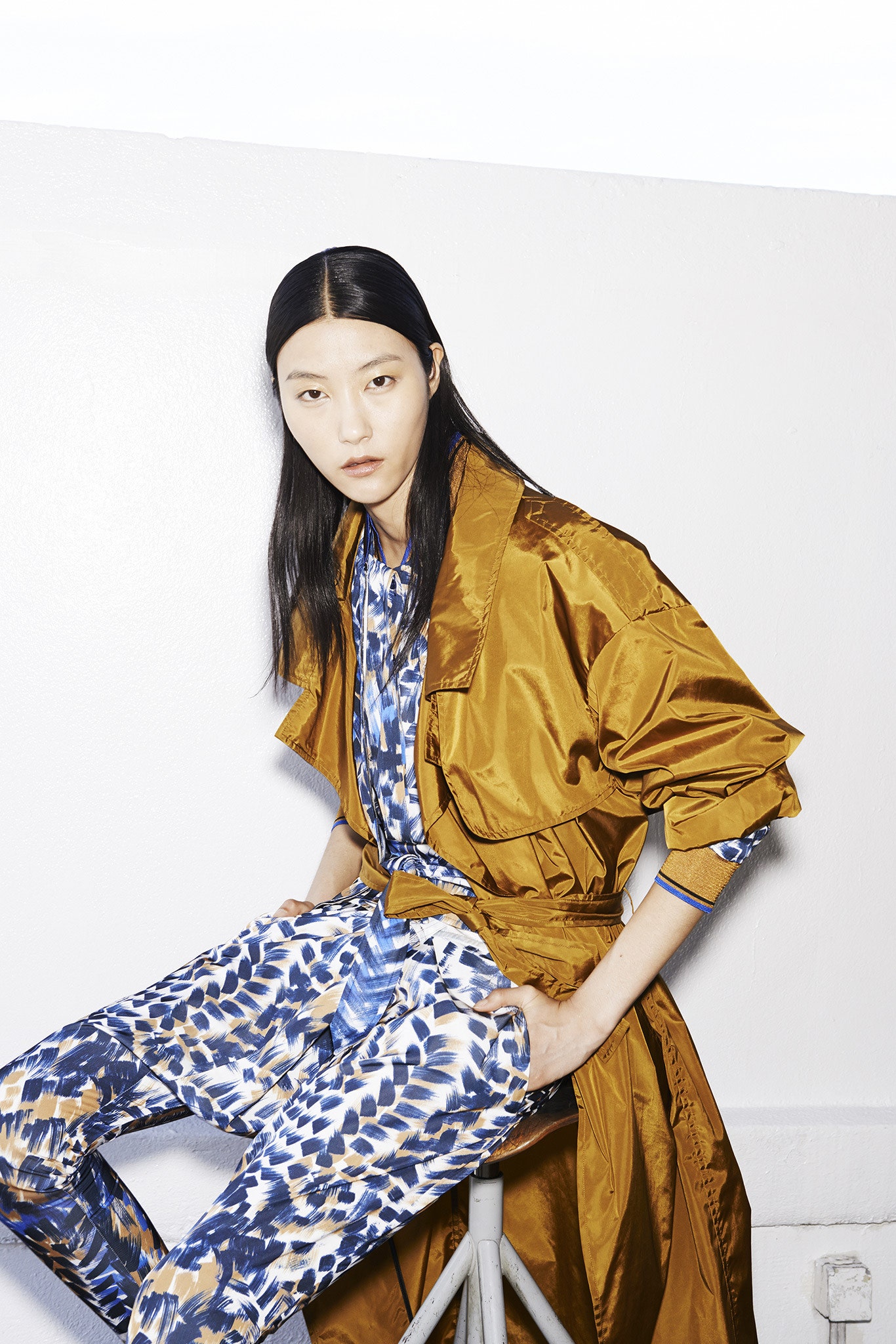 brown silk belted coat and blue printed jumpsuit