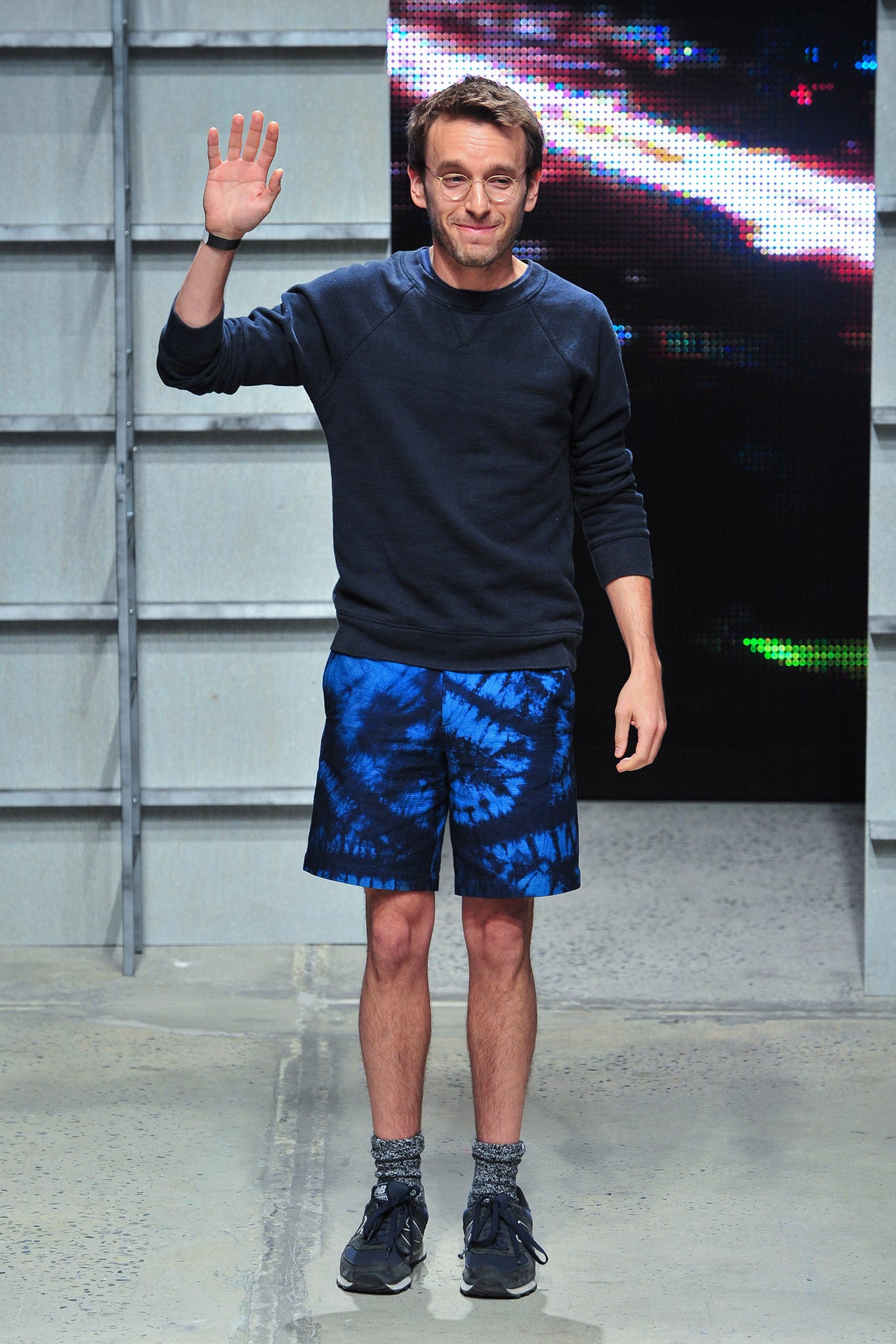black sweater and blue tie-dye shorts