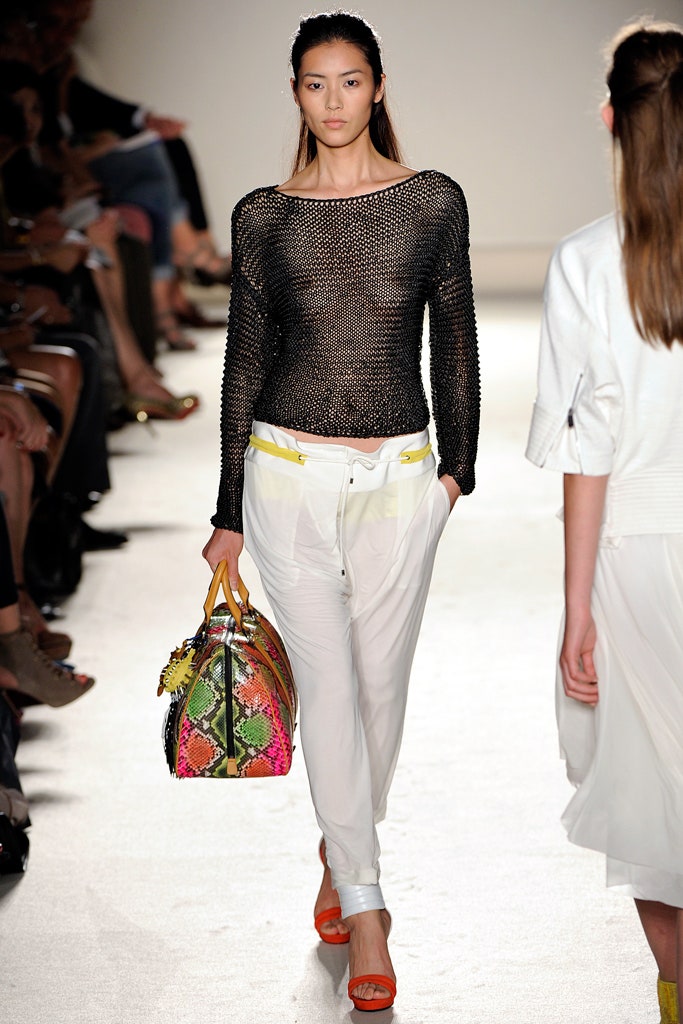 black mesh fitted top with white pants