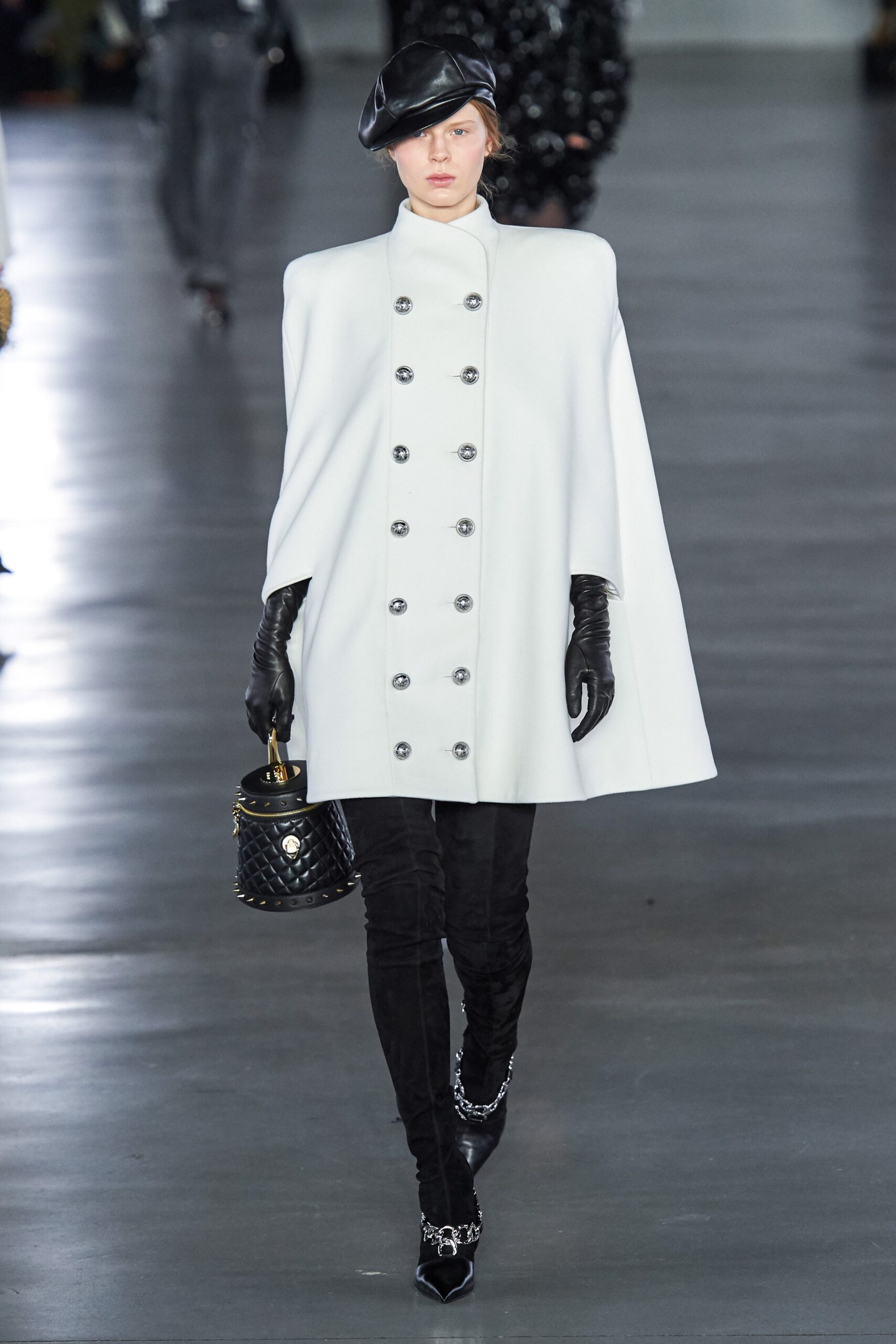 white wool cape with black pants