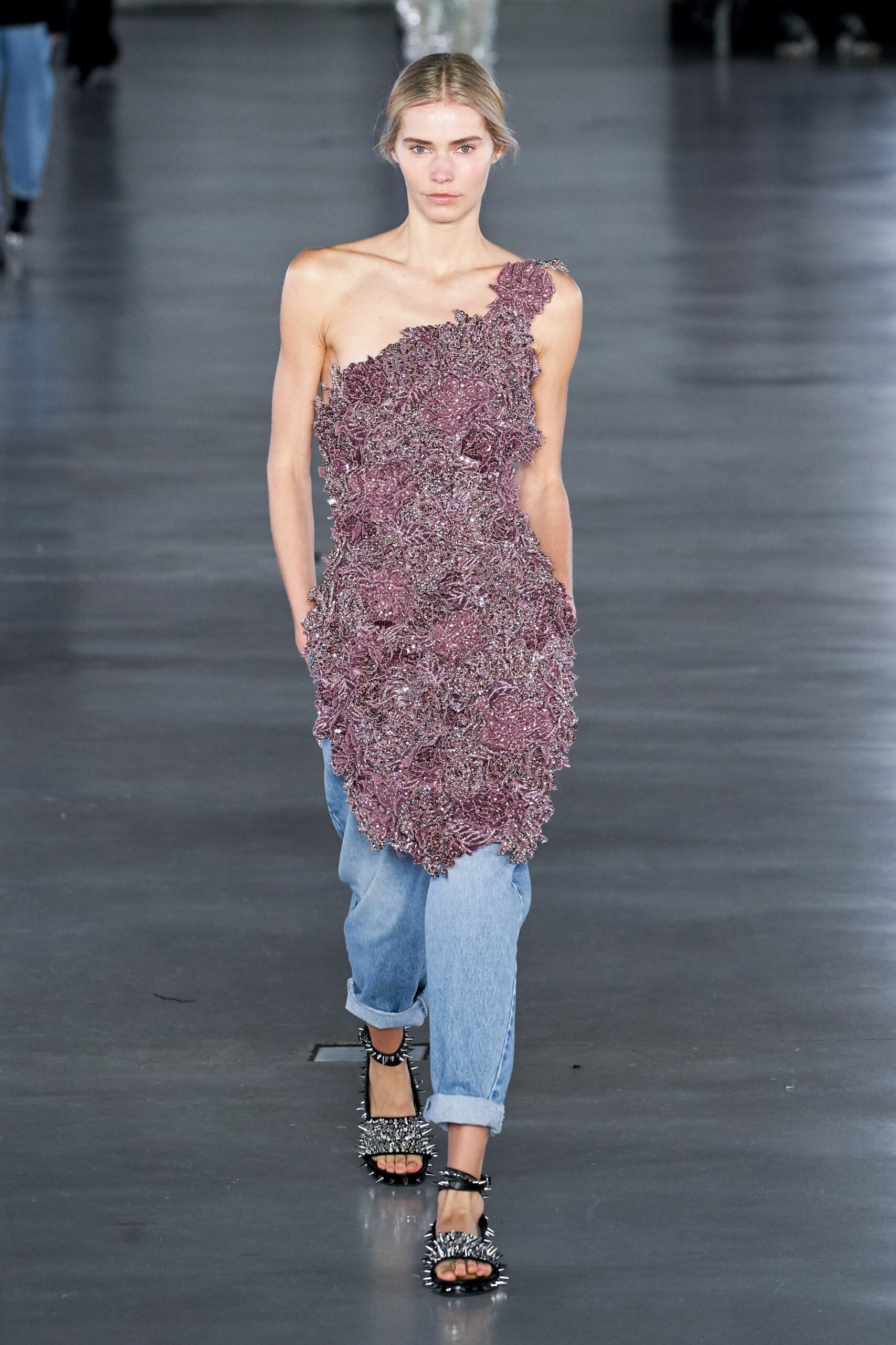 purple asymmetric ruffled dress with denim pants