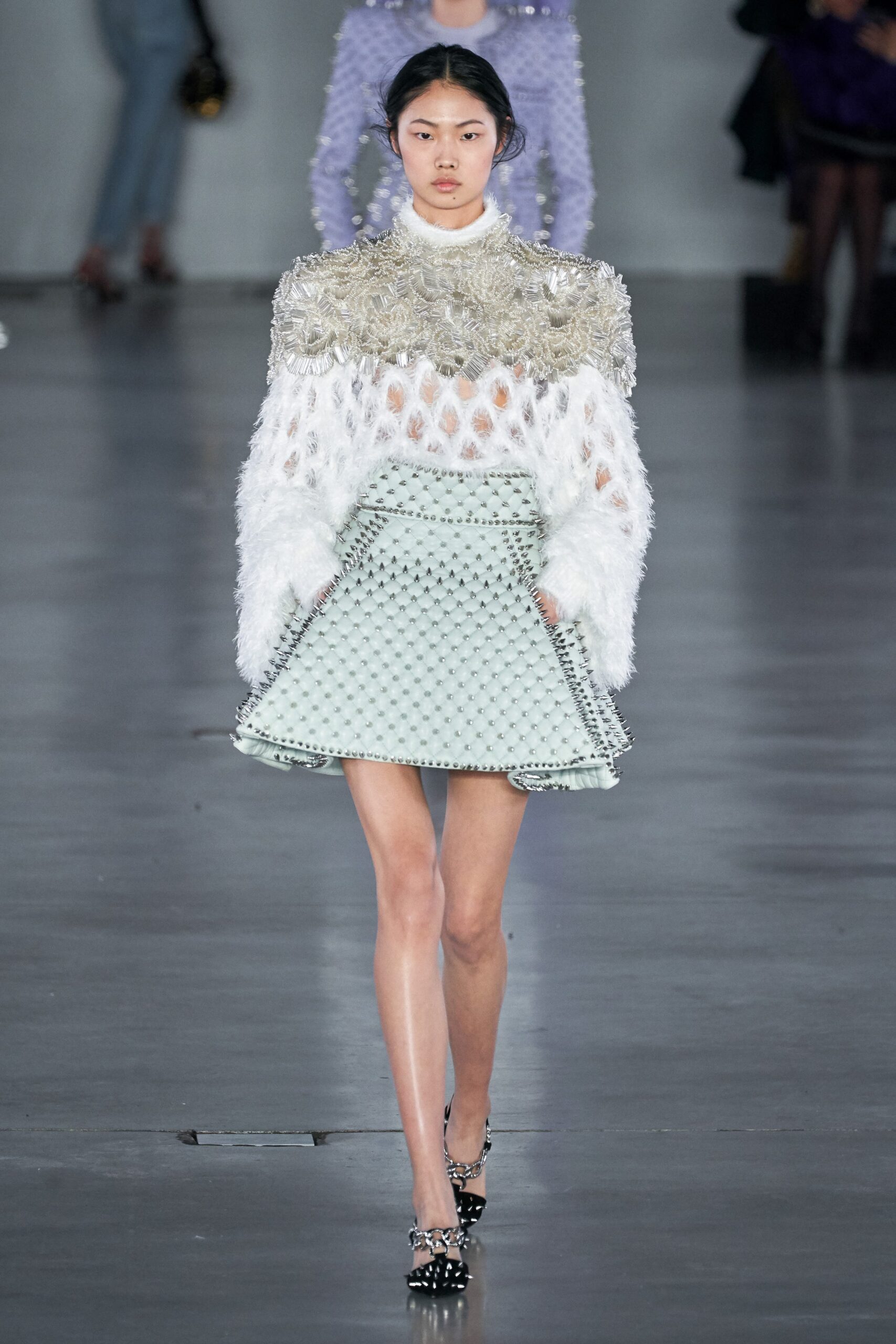 white embroidered top and light blue pleated skirt