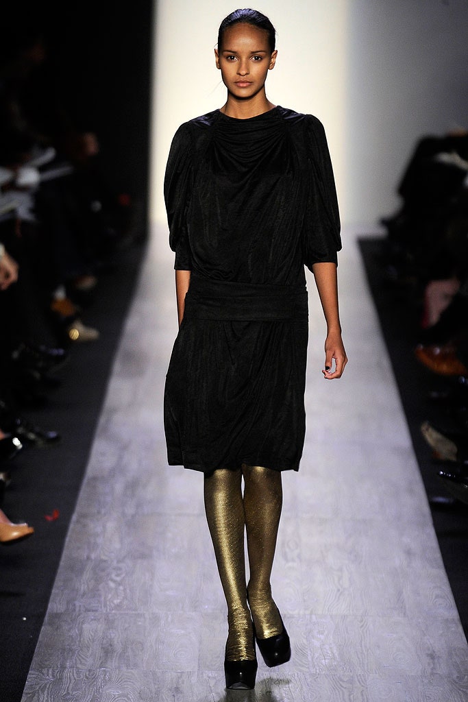 black silk draped midi dress with gold leggings