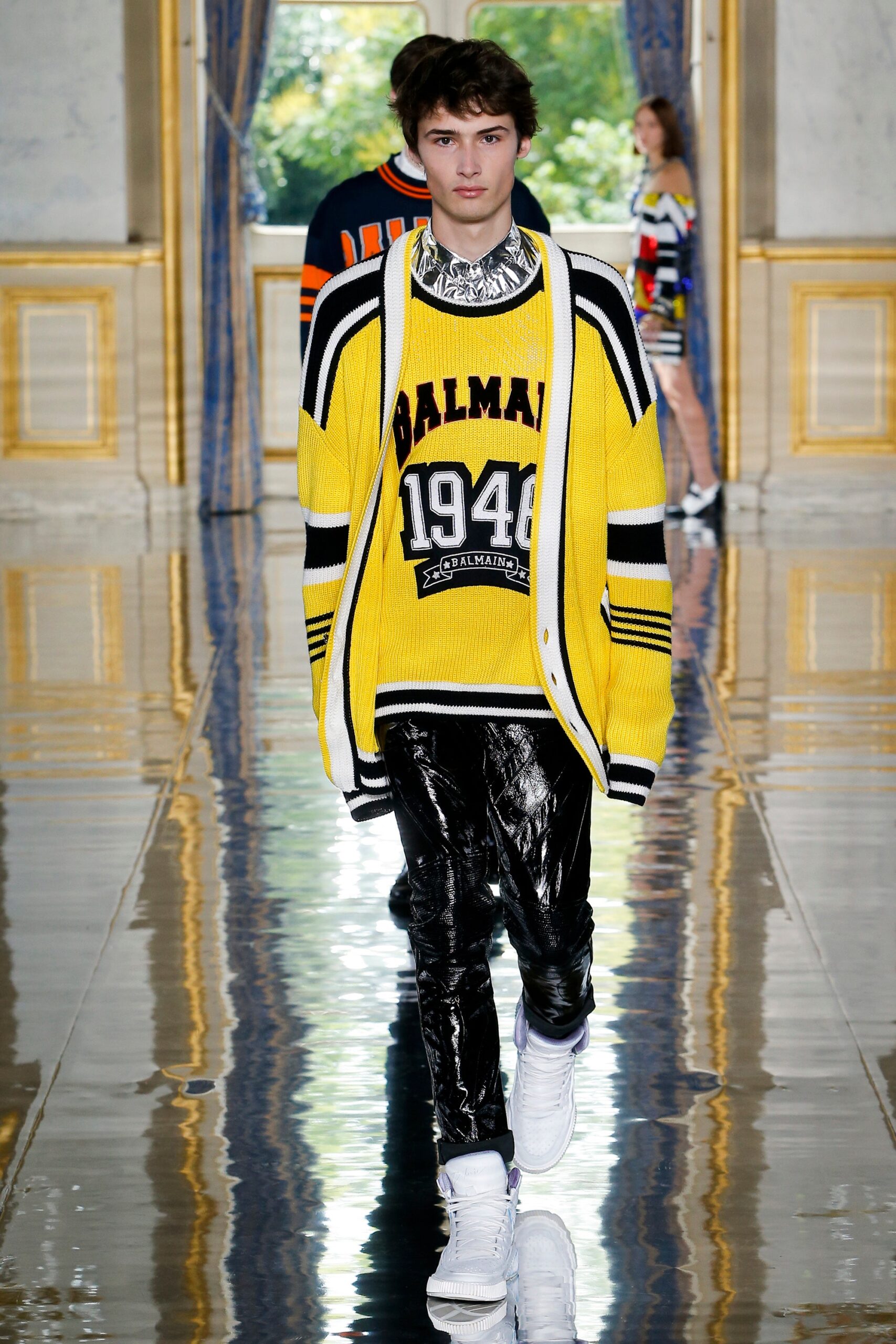 yellow striped sweater with black pants