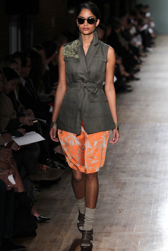 green tailored vest with orange shorts