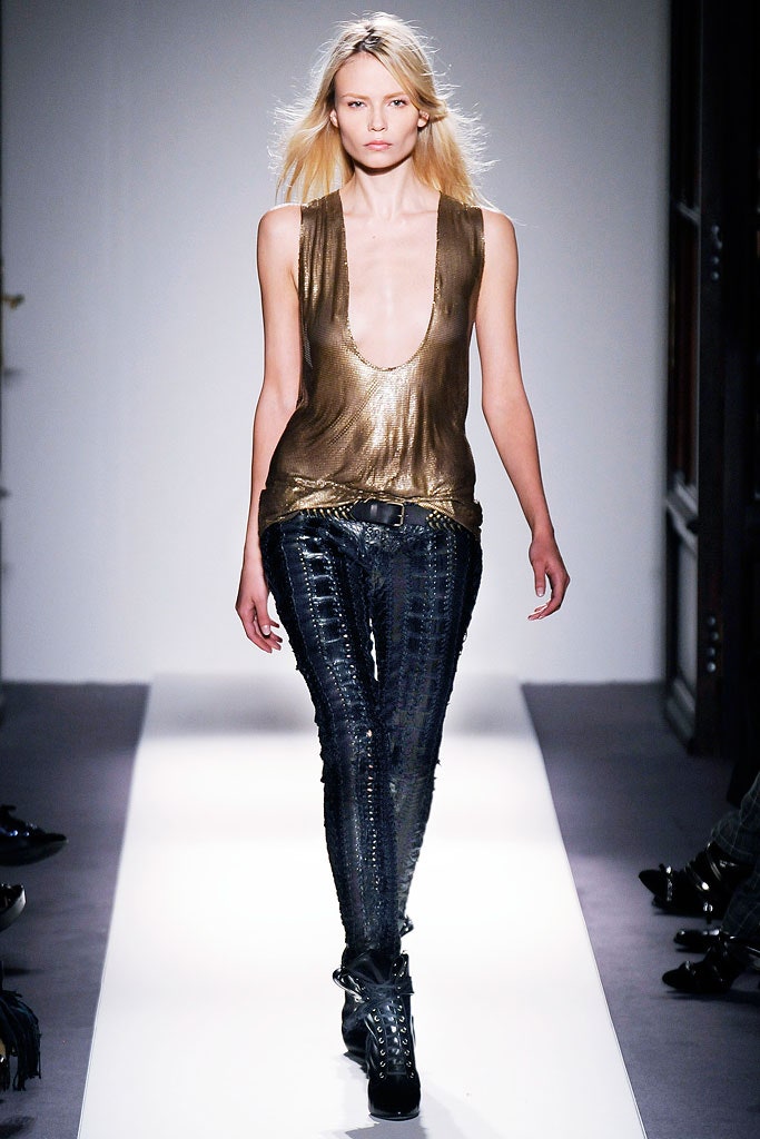 gold silk sleeveless top and black leather pants