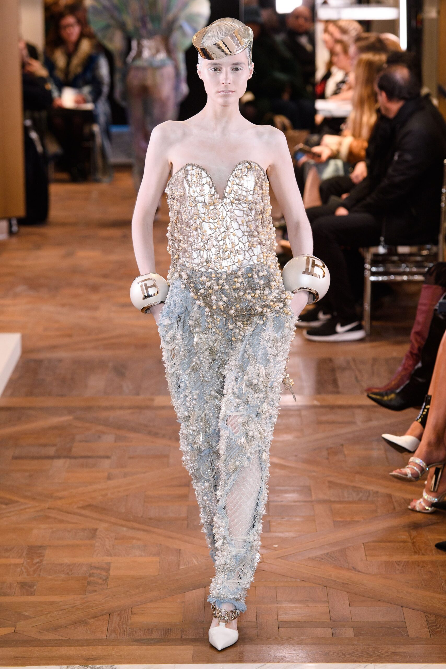 gold beaded strapless top with blue pants