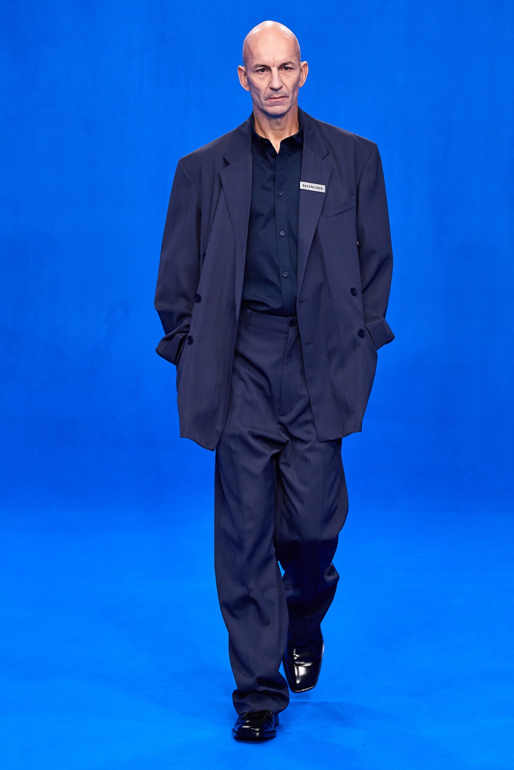 blue tailored suit with black shirt