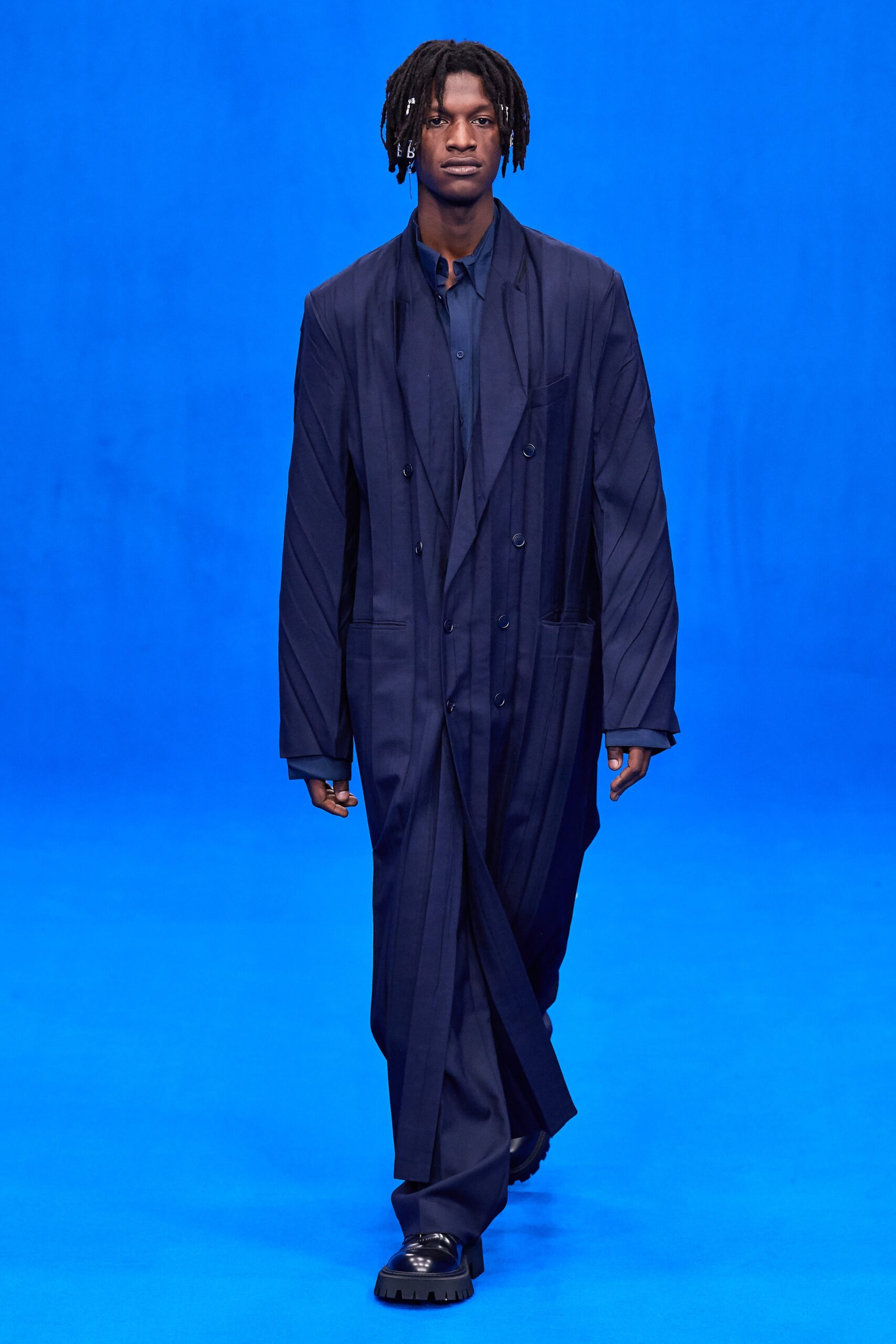 blue relaxed coat with fitted shirt