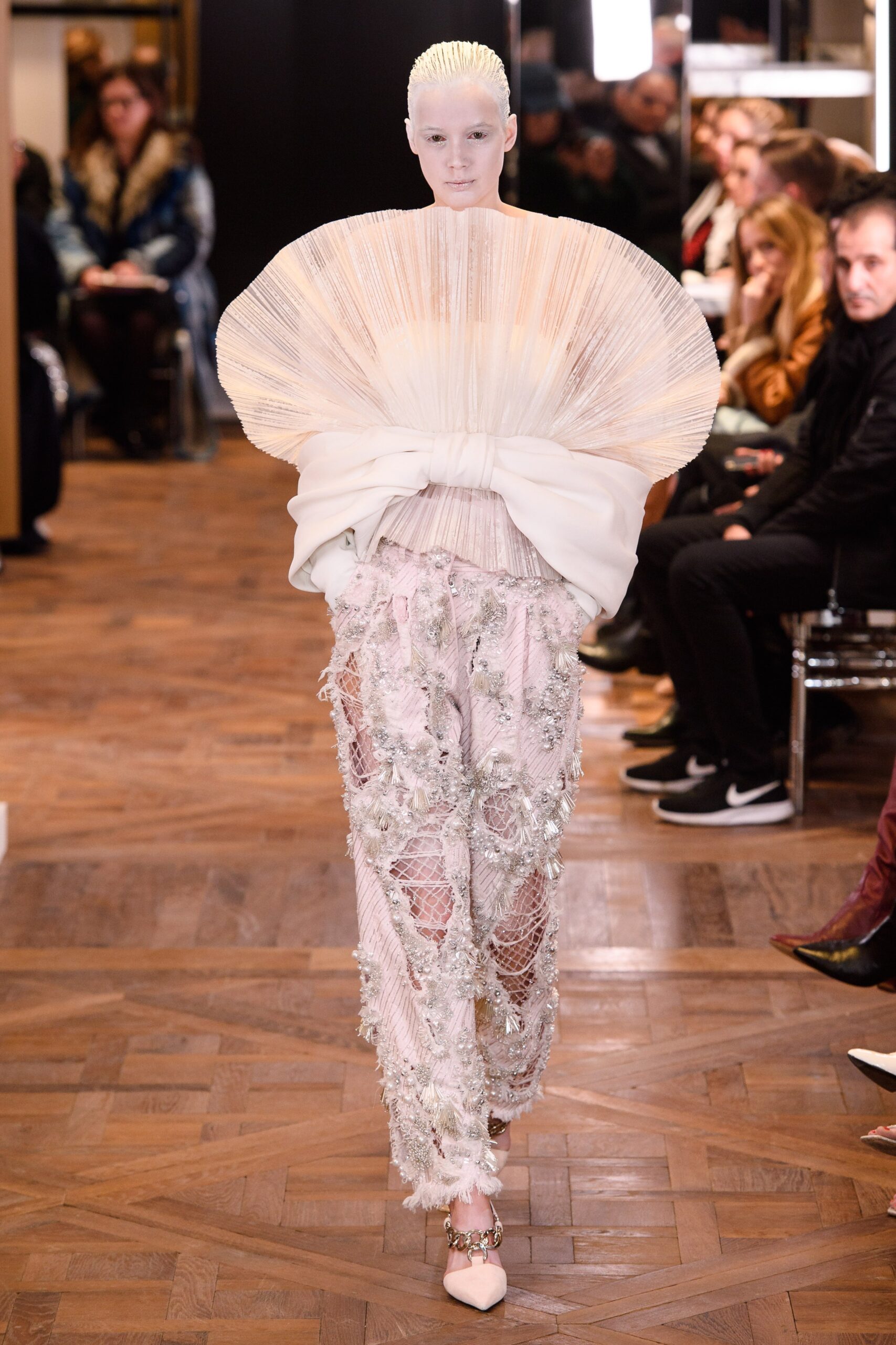 white pleated top and pink embroidered pants