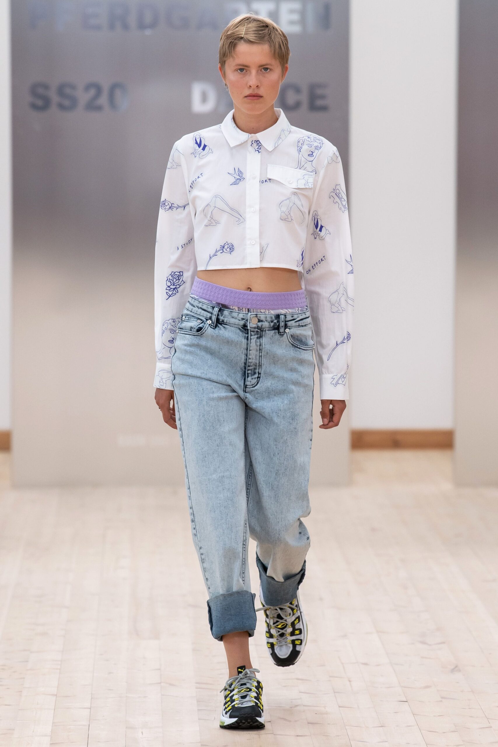 cropped white printed shirt and relaxed denim pants