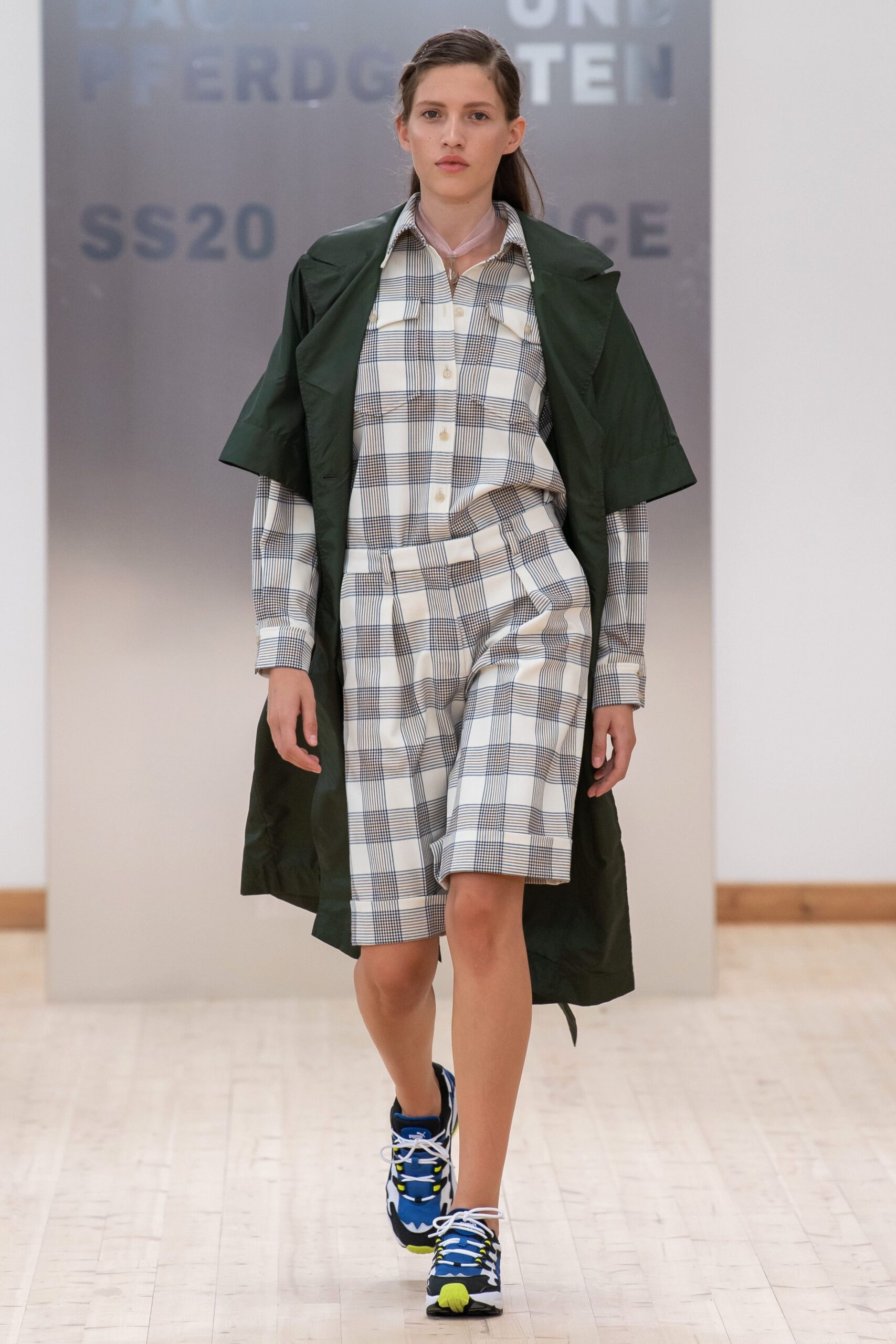 green coat with checked shirt and shorts