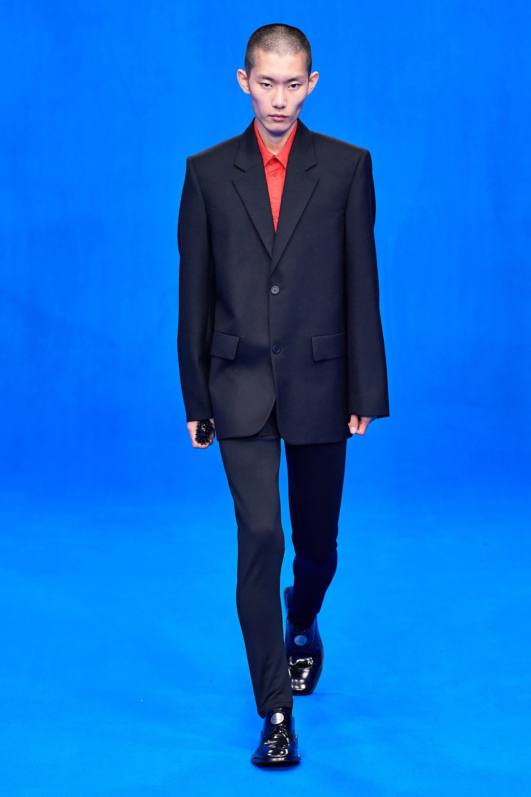 black tailored suit with red shirt