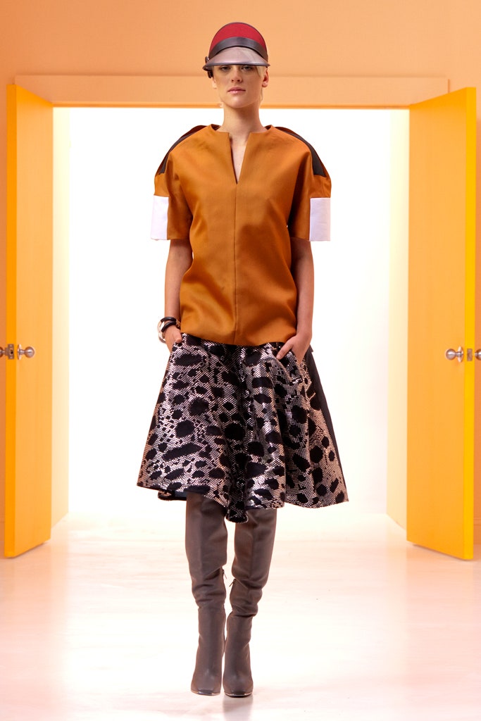 orange fitted top with black skirt