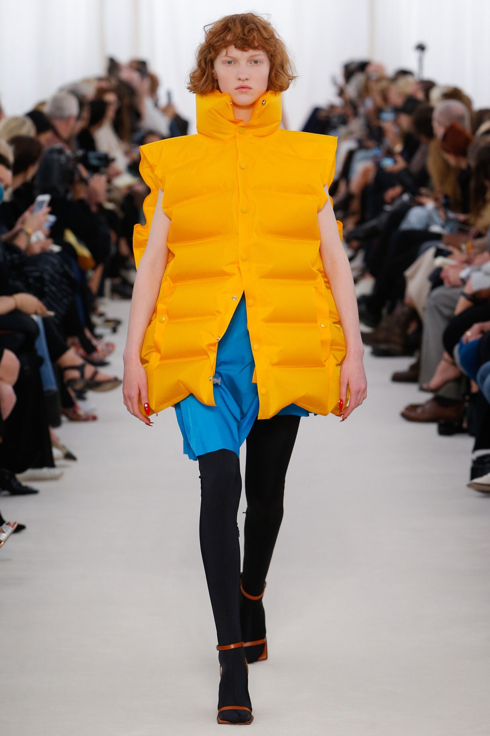 yellow padded vest with blue skirt