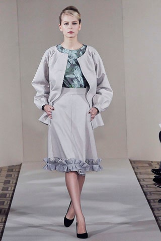 gray jacket green top gray skirt