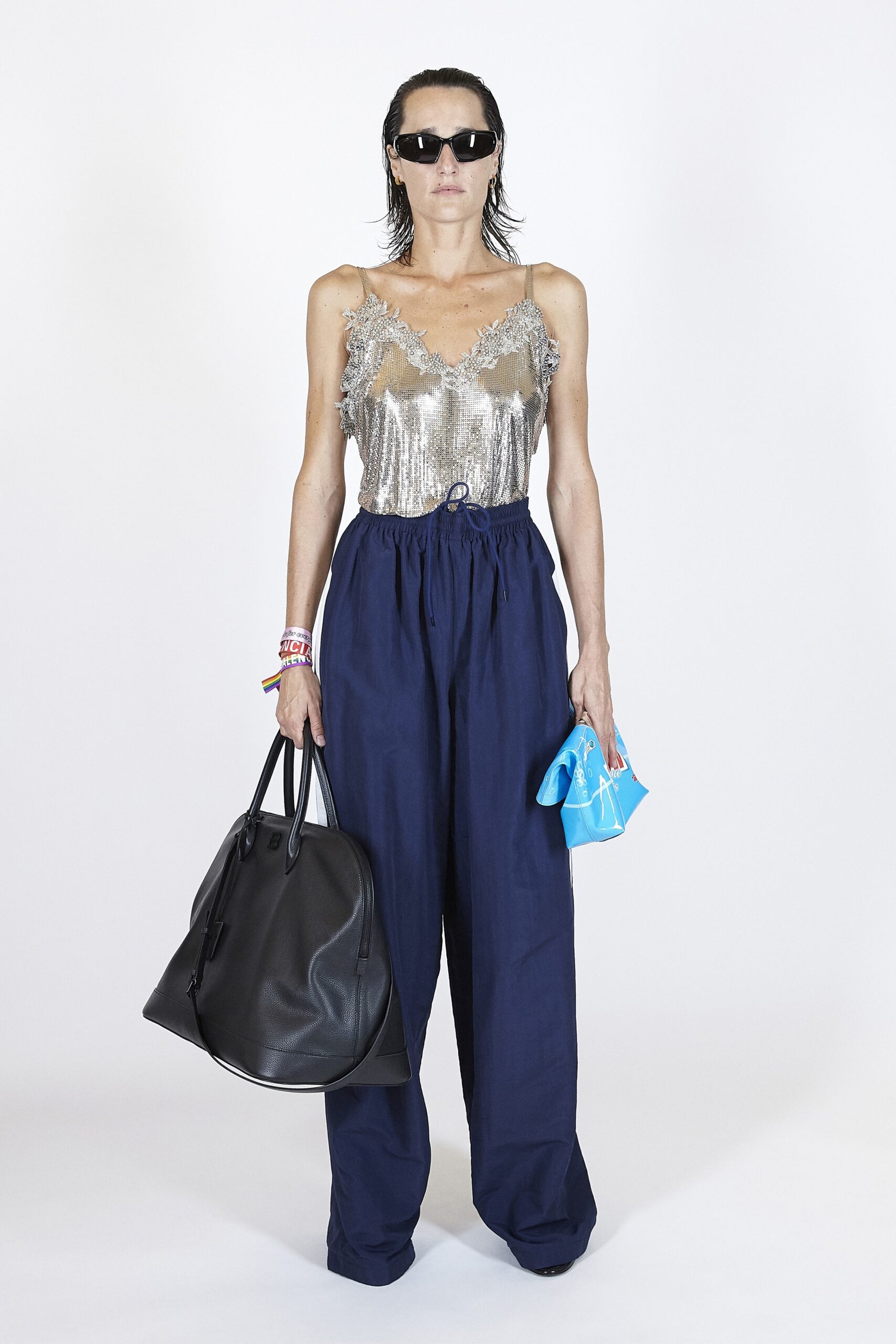 silver embellished sleeveless top and blue wide-leg pants