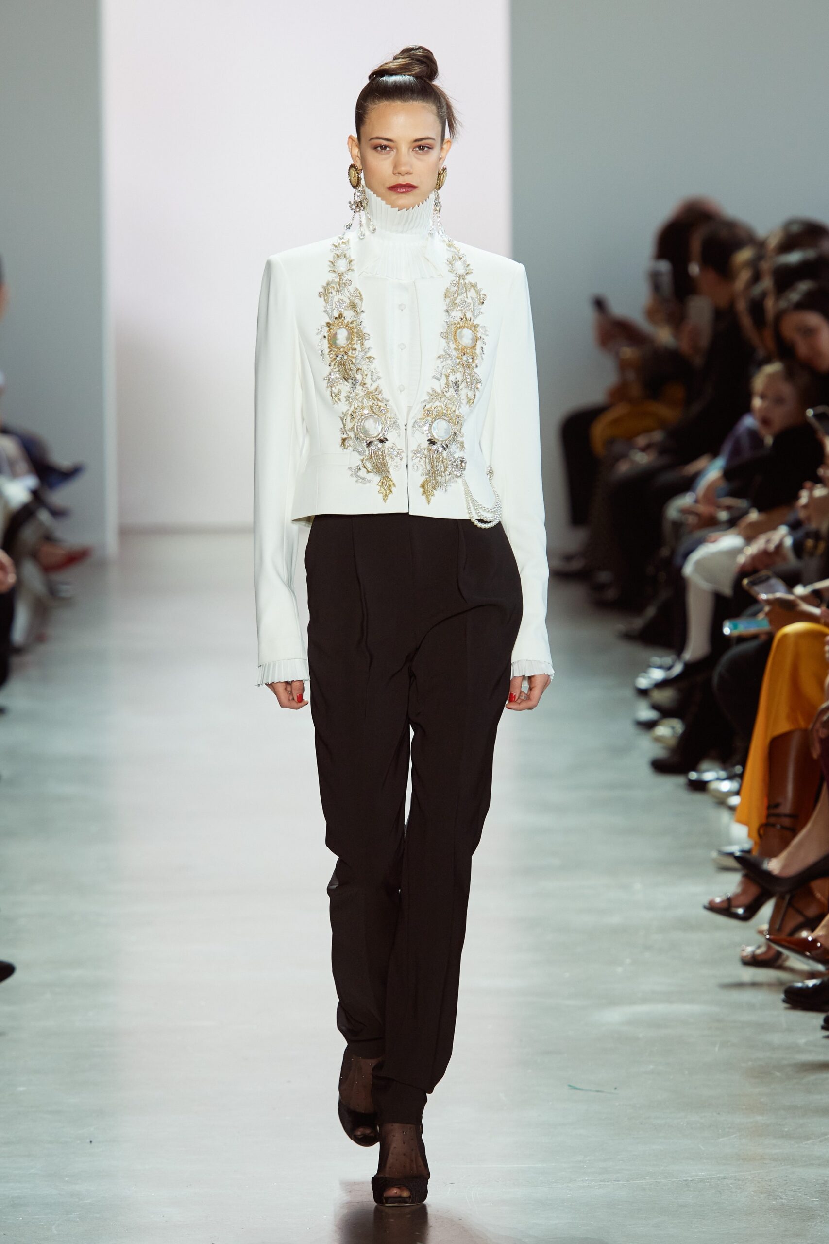 white embroidered blazer and black tailored pants