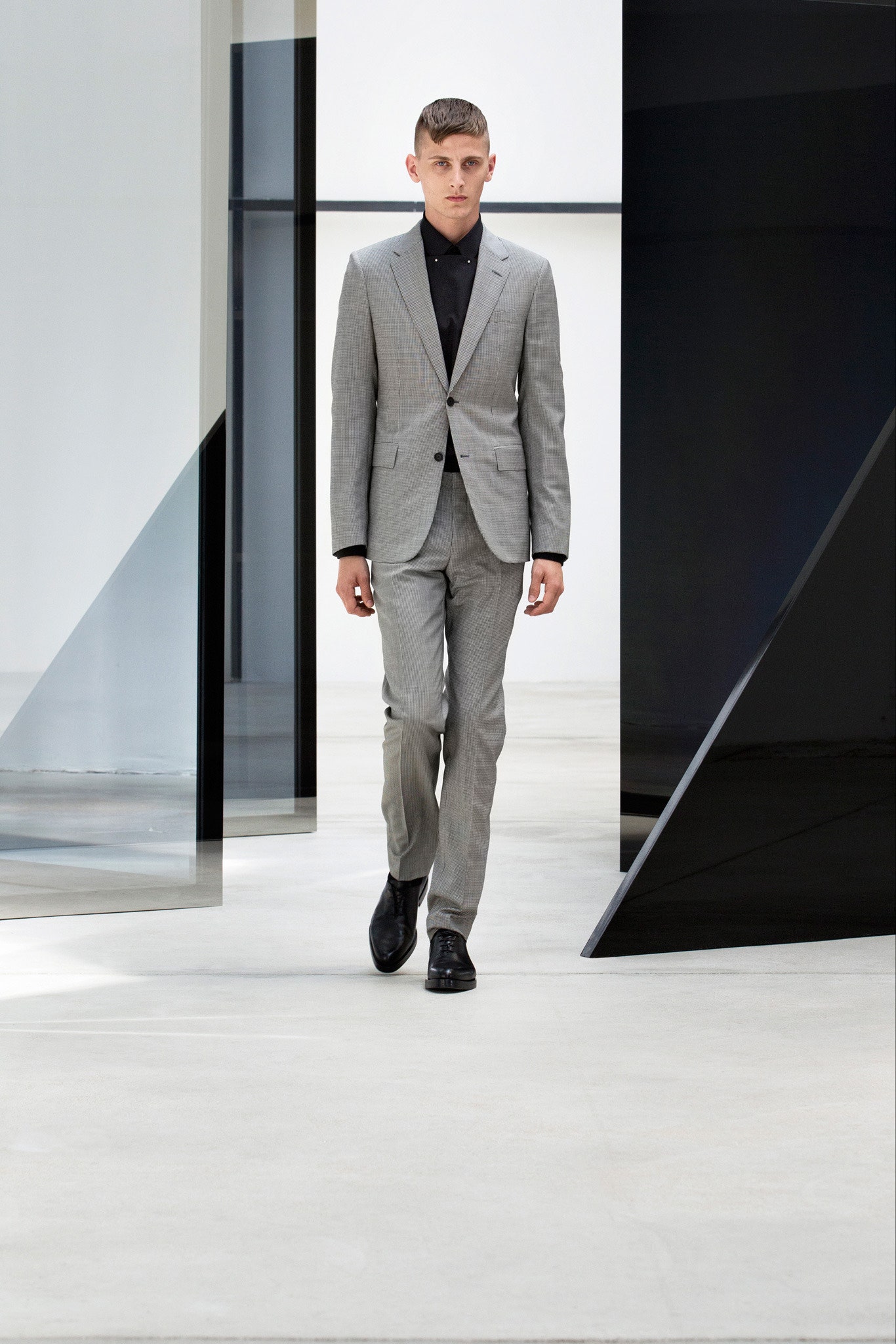 gray tailored suit with black shirt