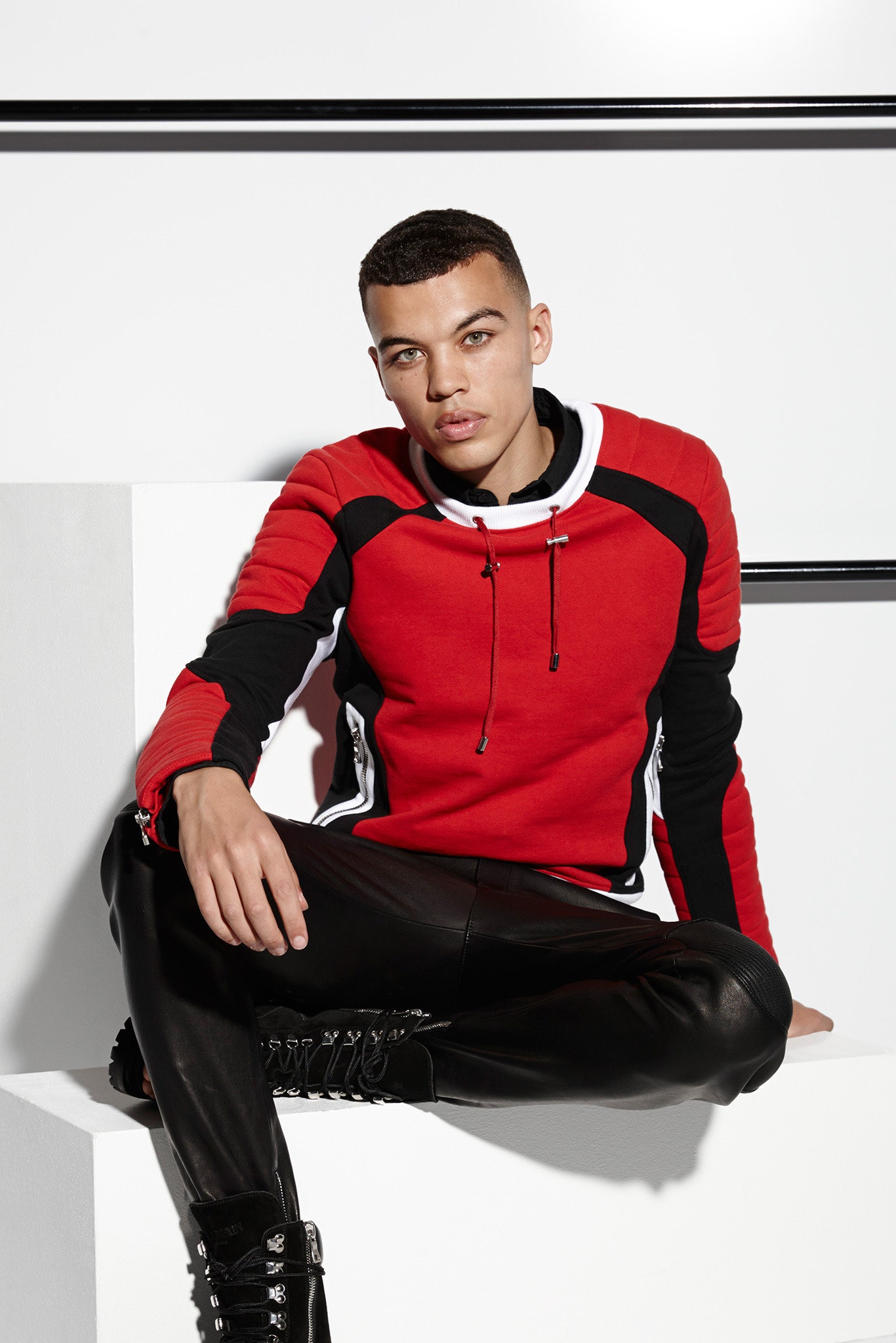 red and black fitted hoodie with leather pants