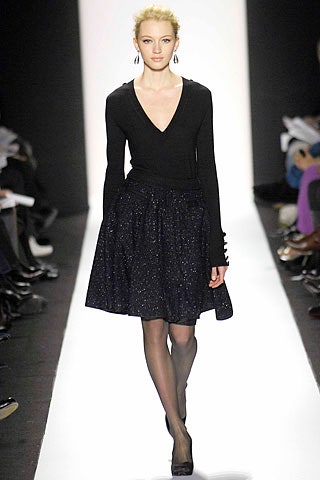 black fitted top and pleated skirt