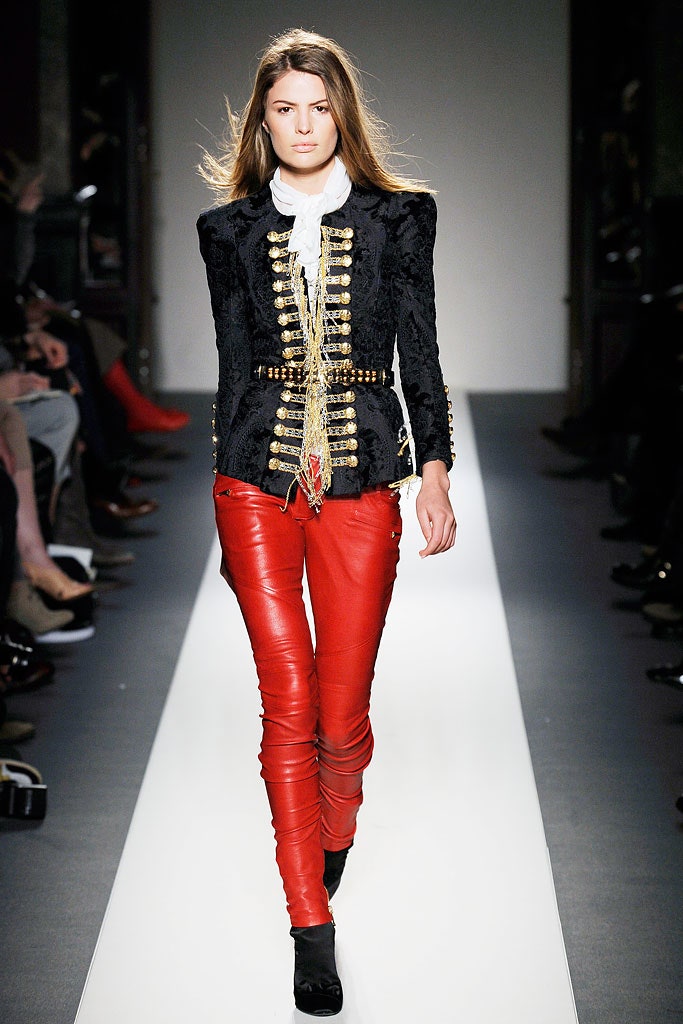 black leather fitted jacket and red pants