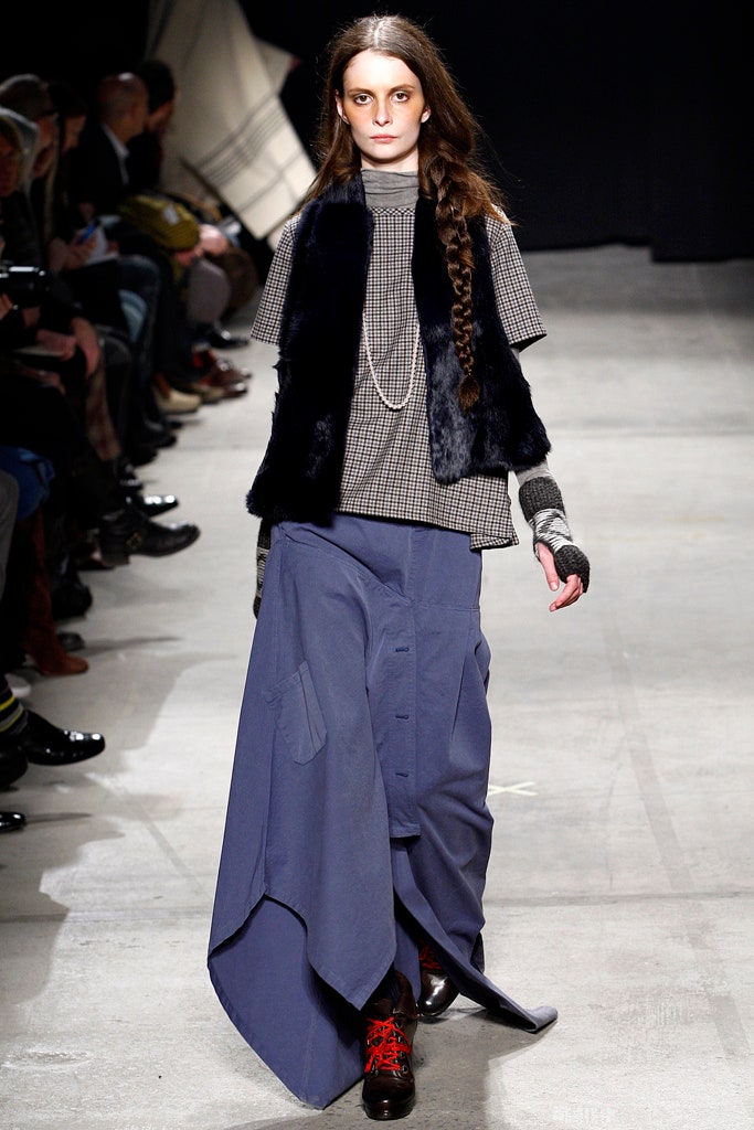 gray top black vest blue skirt