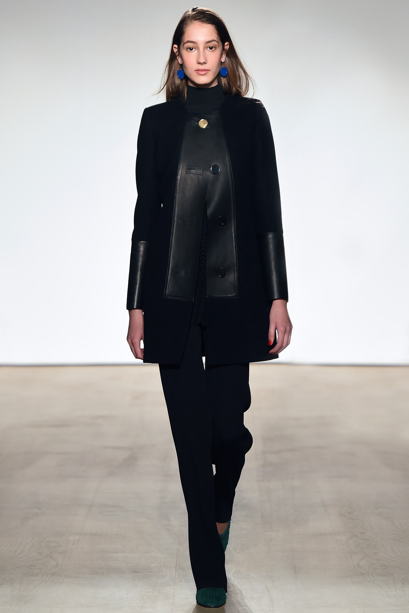 black fitted coat and tailored pants